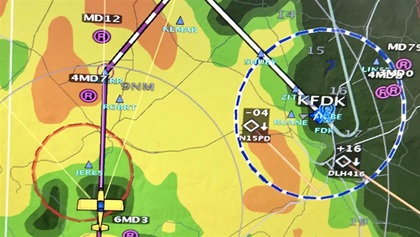 The advanced flight systems MFD shows the AOPA Sweepstakes RV–10 flying over the presidential retreat at Camp David during a GPS approach to its home base at Frederick, Maryland, on a rainy day. The weather imagery is provided by ADS-B.