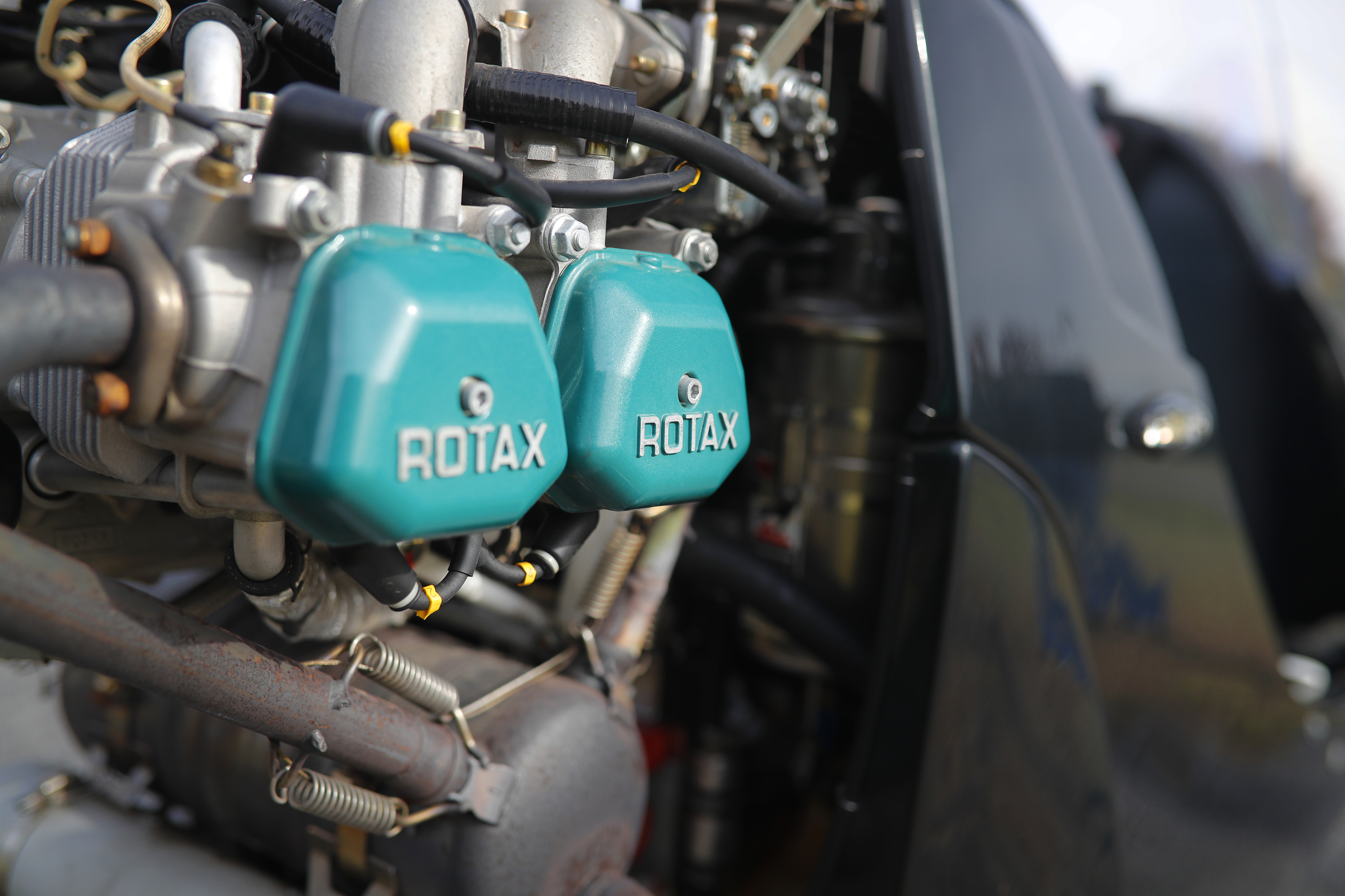 A Rotax engine mounted pusher-style is exposed and ready to preflight.