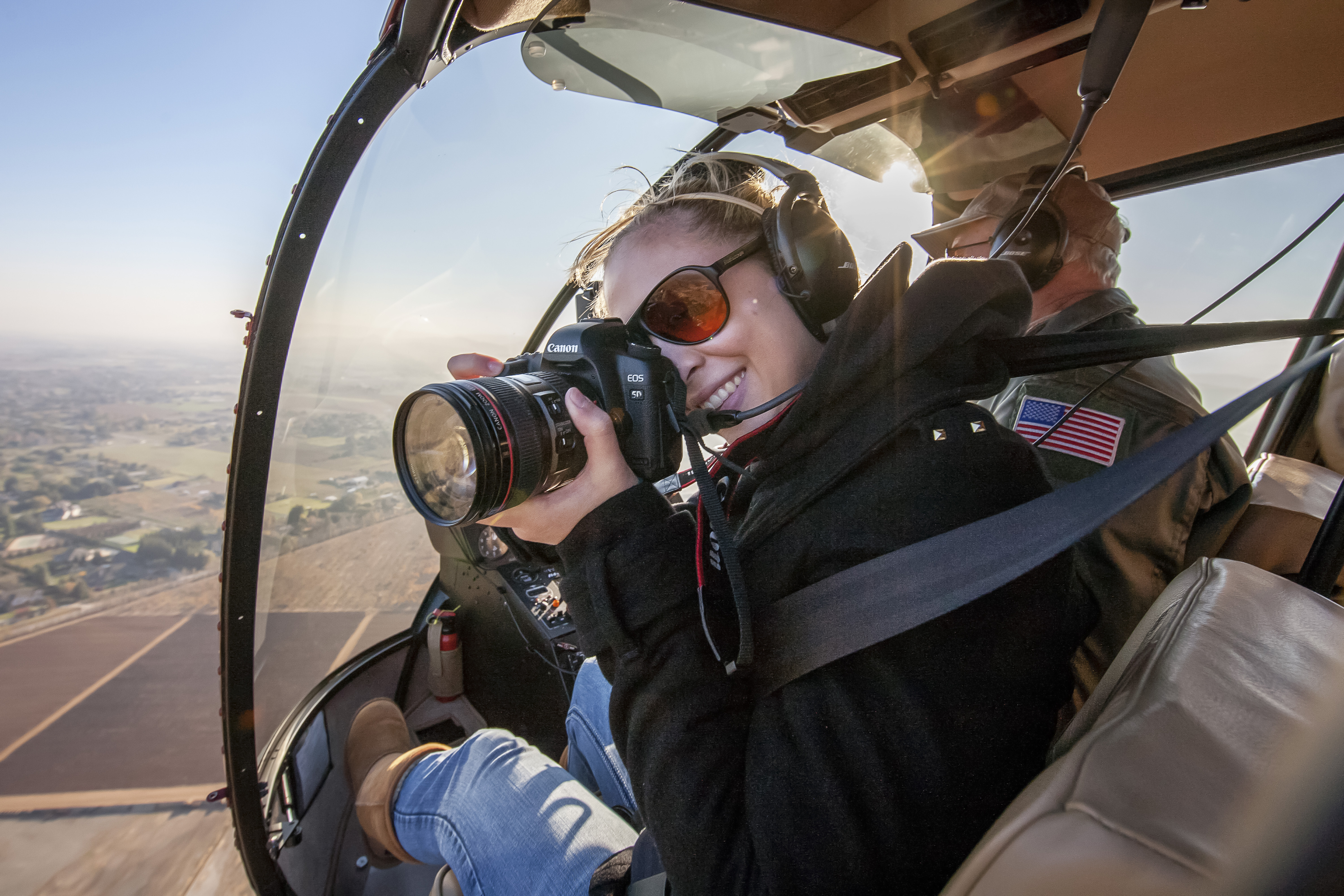 Granddaughter Niki is both photographer and pilot, here flying with her father Pat Belanger in their company’s helicopter.