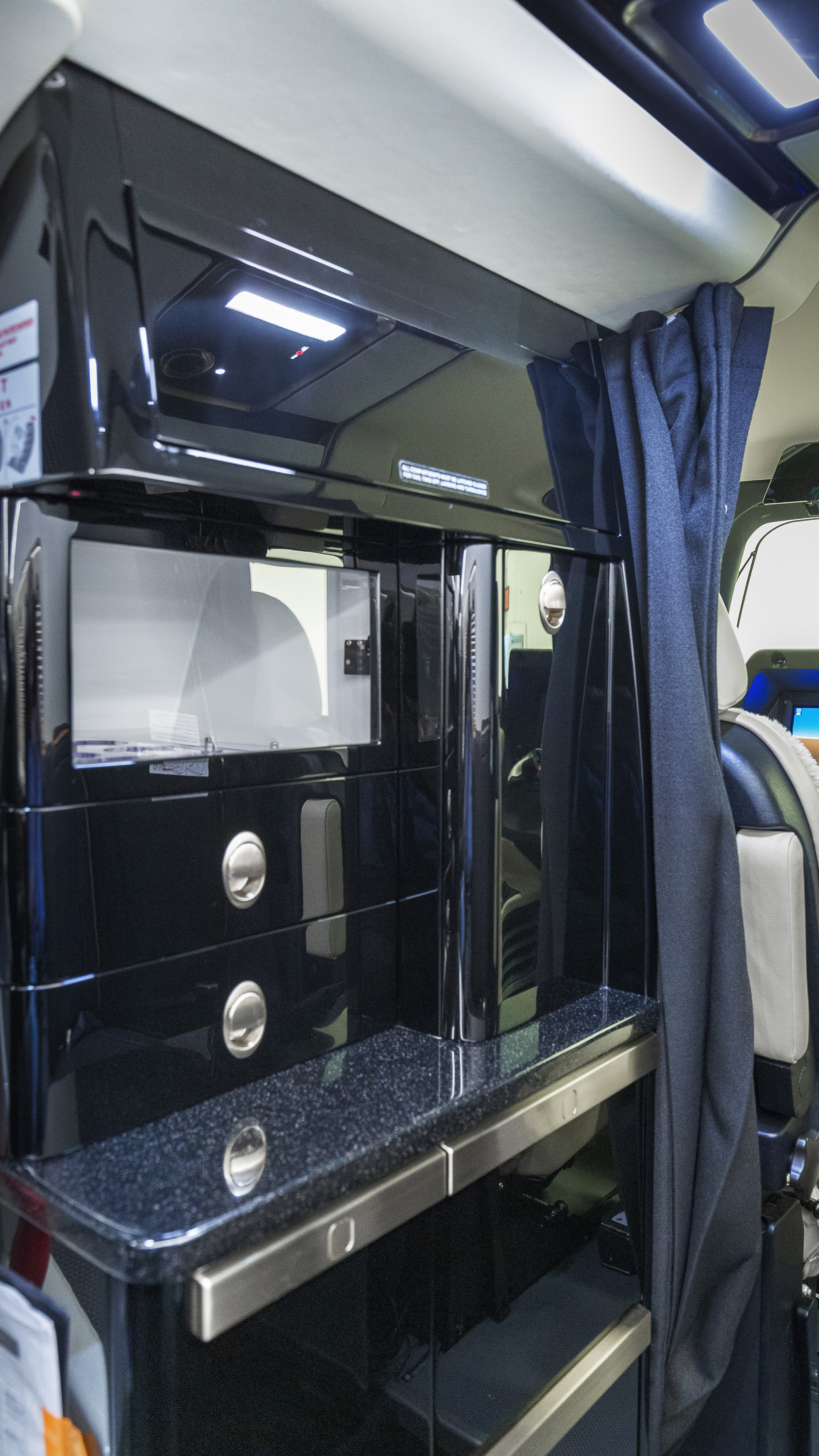 The high-density cabin has a forward galley, a side-facing divan, and room for nine cabin seats.