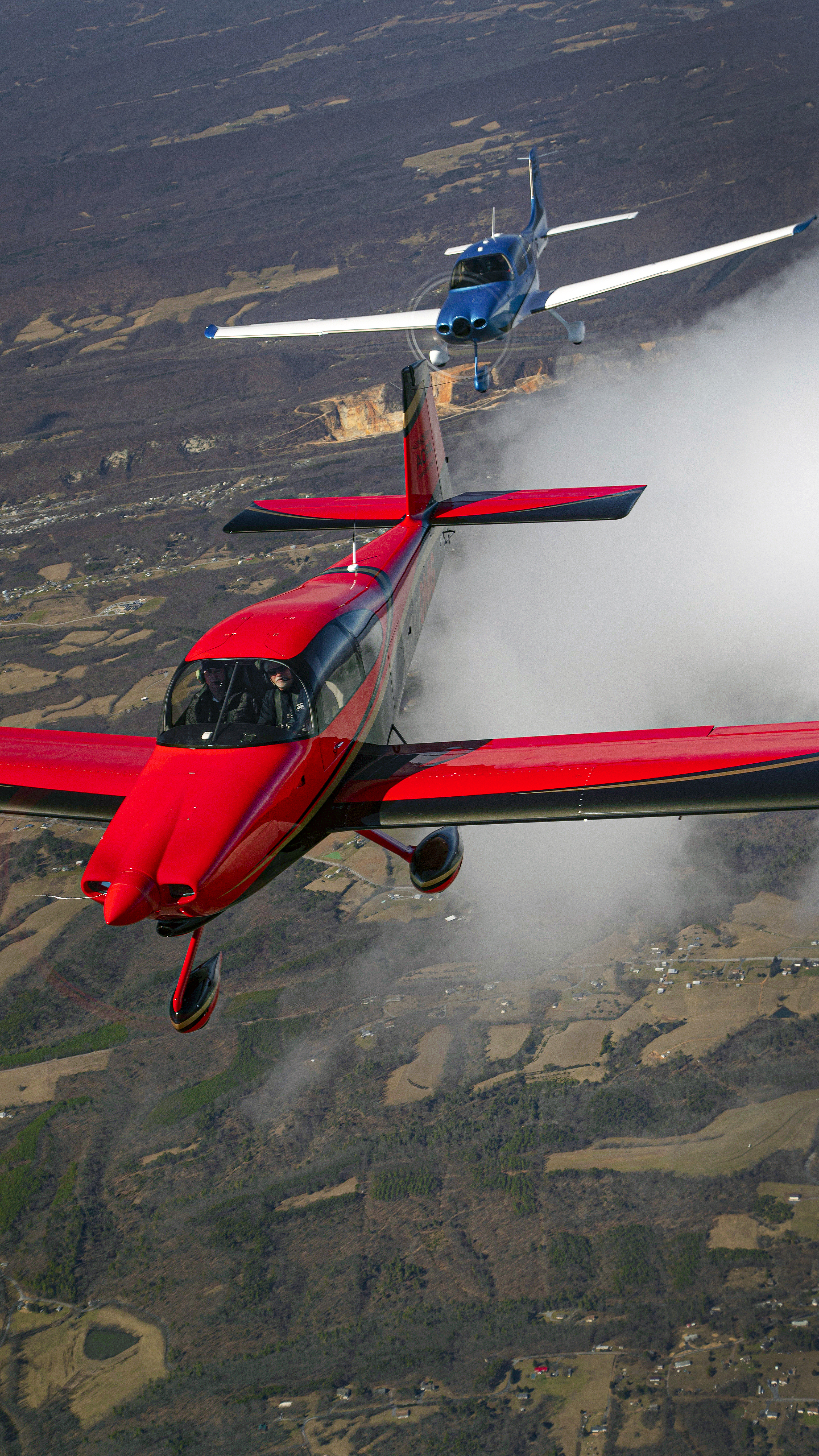 The drag race portion of this contest between the RV–10 (red, foreground) and the SR22 (blue, background) took place high above West Virginia on a cold, blustery morning. The RV–10 was built in Canada and first flew in 2007. The SR22 was built in Duluth, Minnesota, and was delivered in 2010.