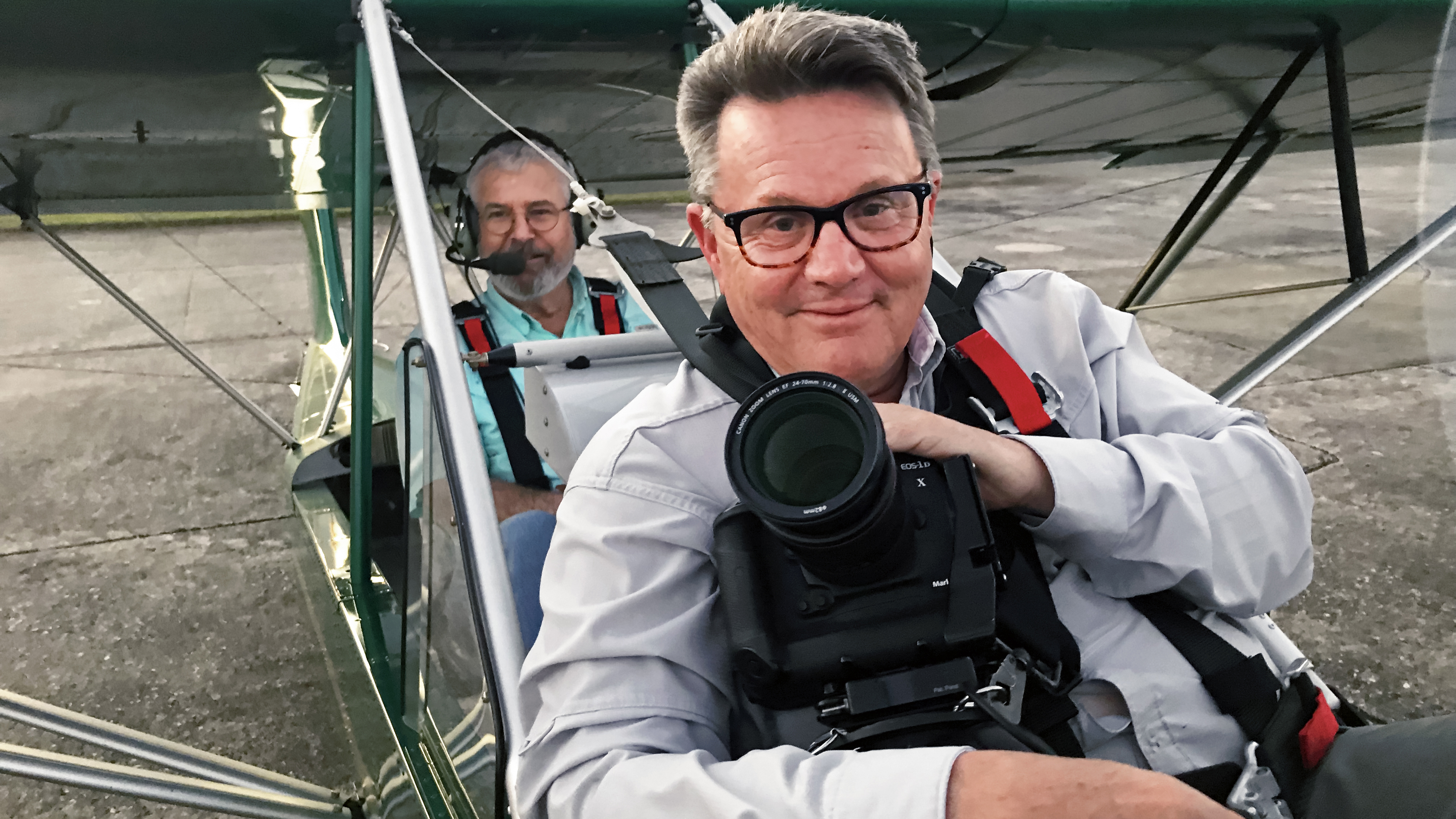 The elusive Mike Fizer began his aviation photography career as a teenager—but he detests appearing in photos. Here, he’s strapped into the front seat of an AirCam (with pilot Robert Meyer) for an air-to-air shoot in Florida. (Dave Hirschman)