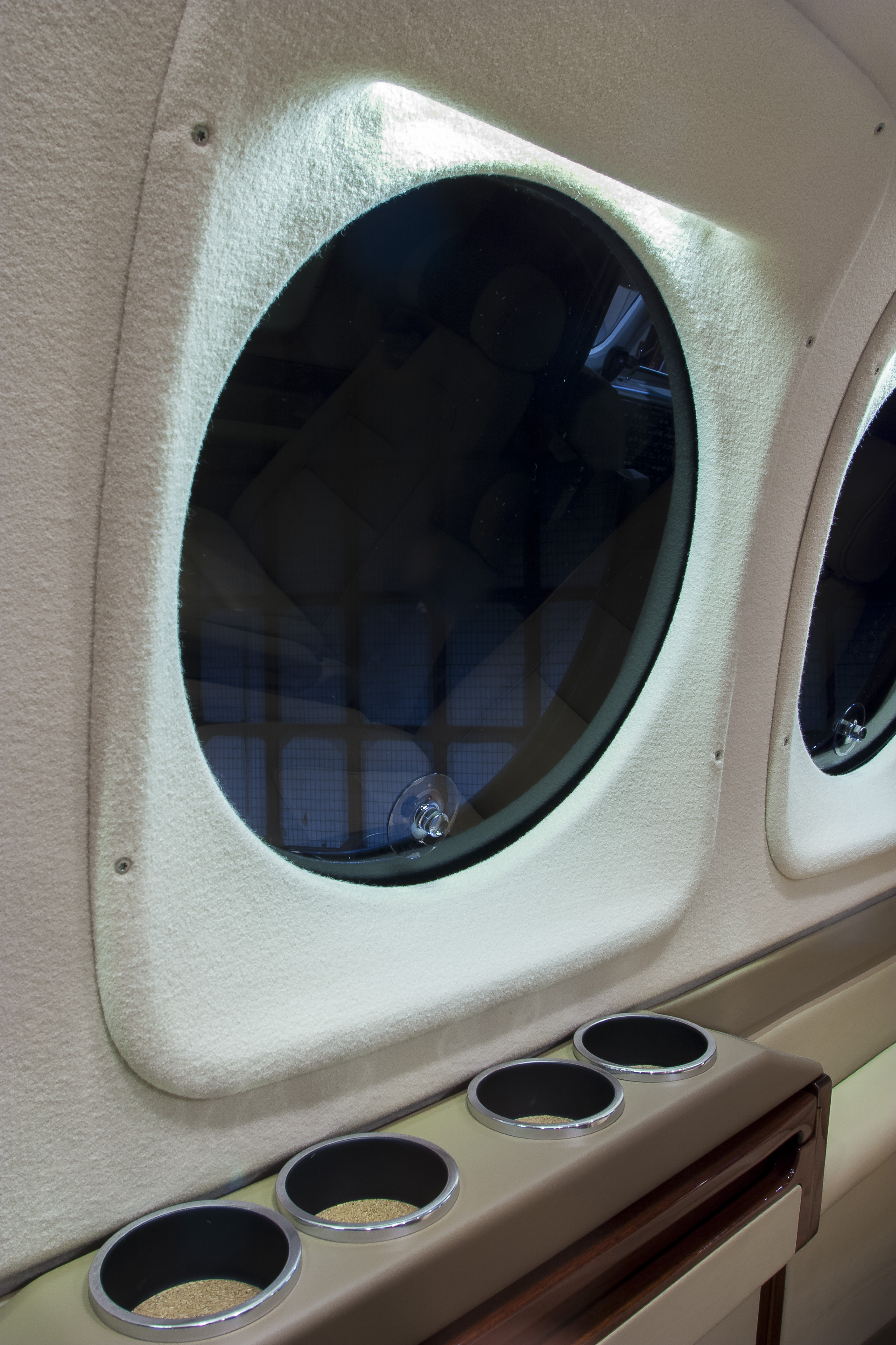 Beechcraft King Air C90: To help block strong sunlight, a vintage King Air C90 window with manually rotatable polarizing screen. 