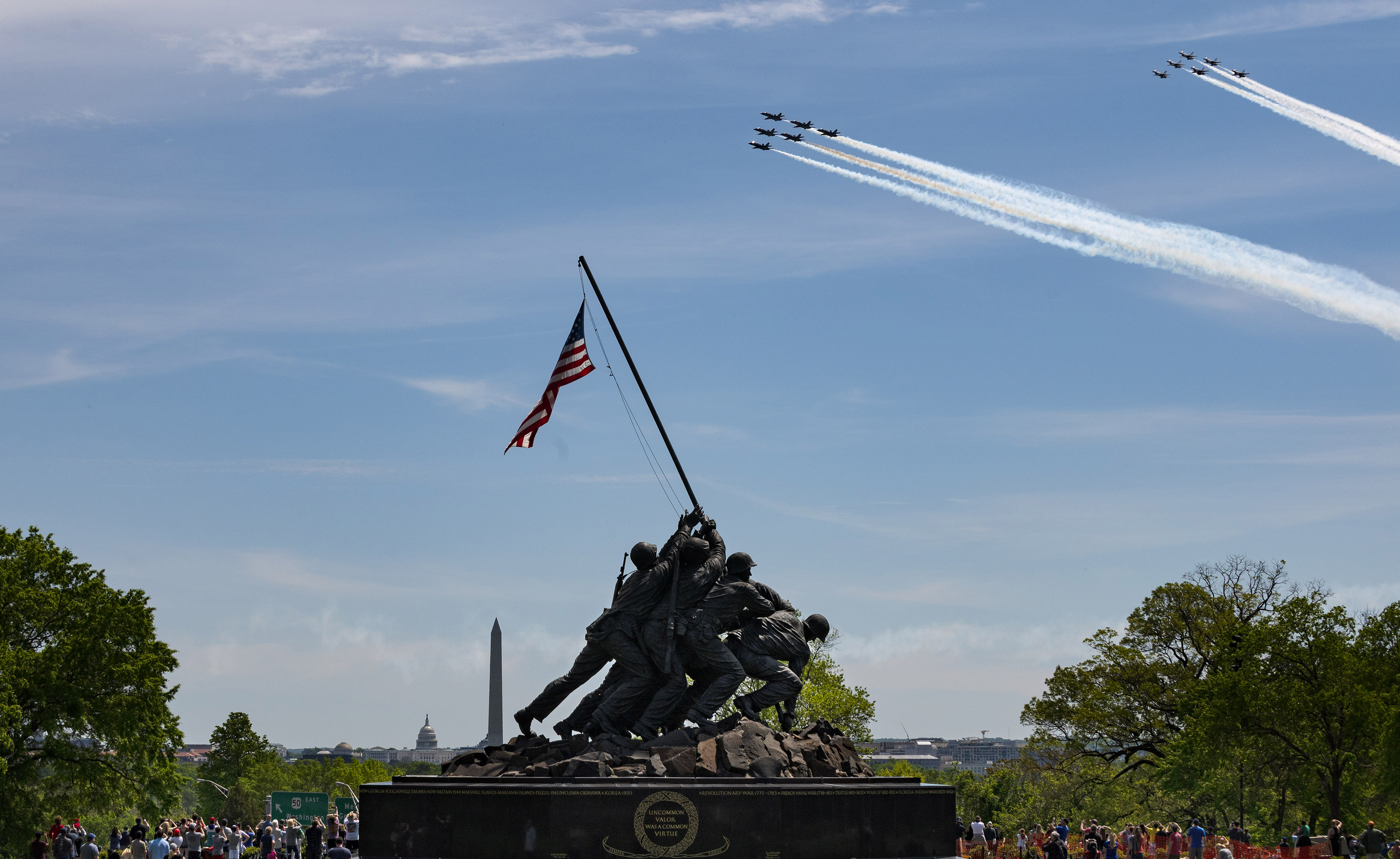 “Thunderbirds and Blue Angels Salute Coronavirus Frontline Workers, Victims” Spectators gather at the U.S. Marine Corps War Memorial to watch the U.S. Air Force Thunderbirds and U.S. Navy Blue Angels air demonstration teams perform a salute to health care workers and others battling the coronavirus during a flyover of Washington, D.C. I used a very fast shutter speed to capture the two teams of military jets above the monument. (Nikon Z6, 70mm, 1/3200, f11.0)