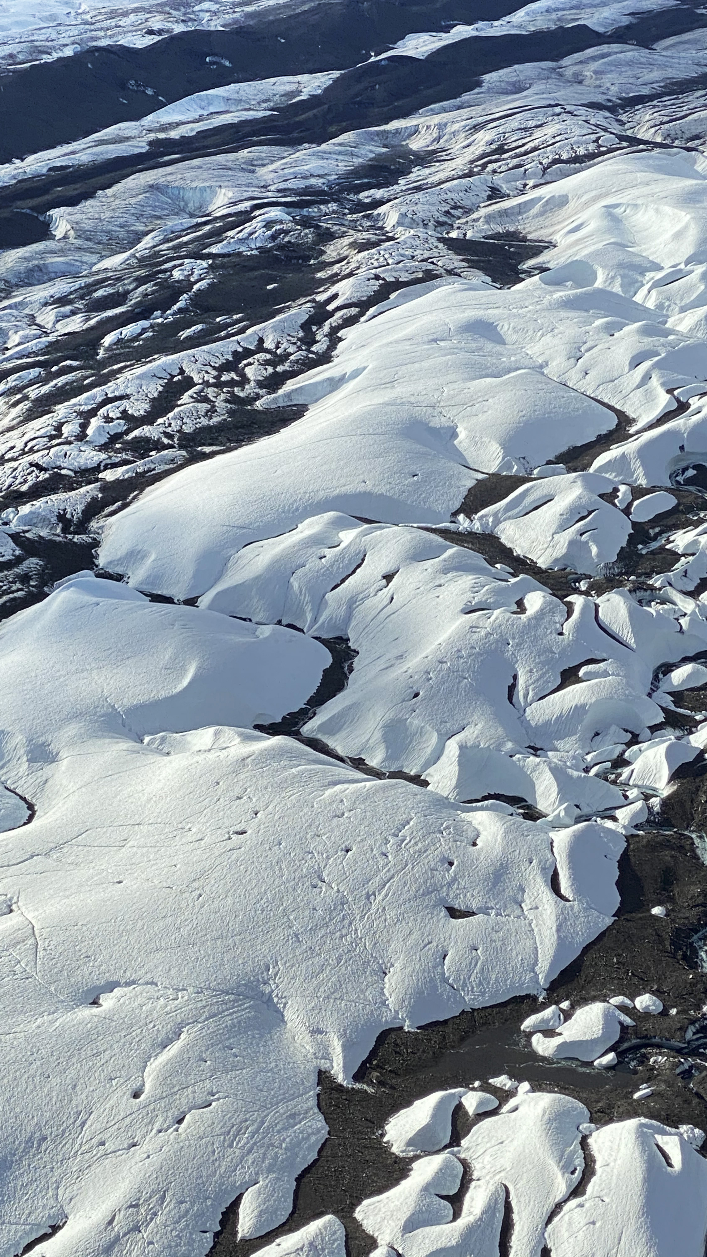 Midway point of Ruth Glacier: This image shows shrinkage of the glacier ice where new streams form every year that eventually drain into the Ruth River and then the Chulitna River. This large-scale melting adds to the high water events on the Chulitna River that drains into the Susitna River.