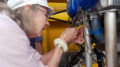 Course participant Fay Taylor begins the first steps of checking an aircraft engine’s timing, part of the hands-on training in Blue Ridge’s light sport repairman course.
