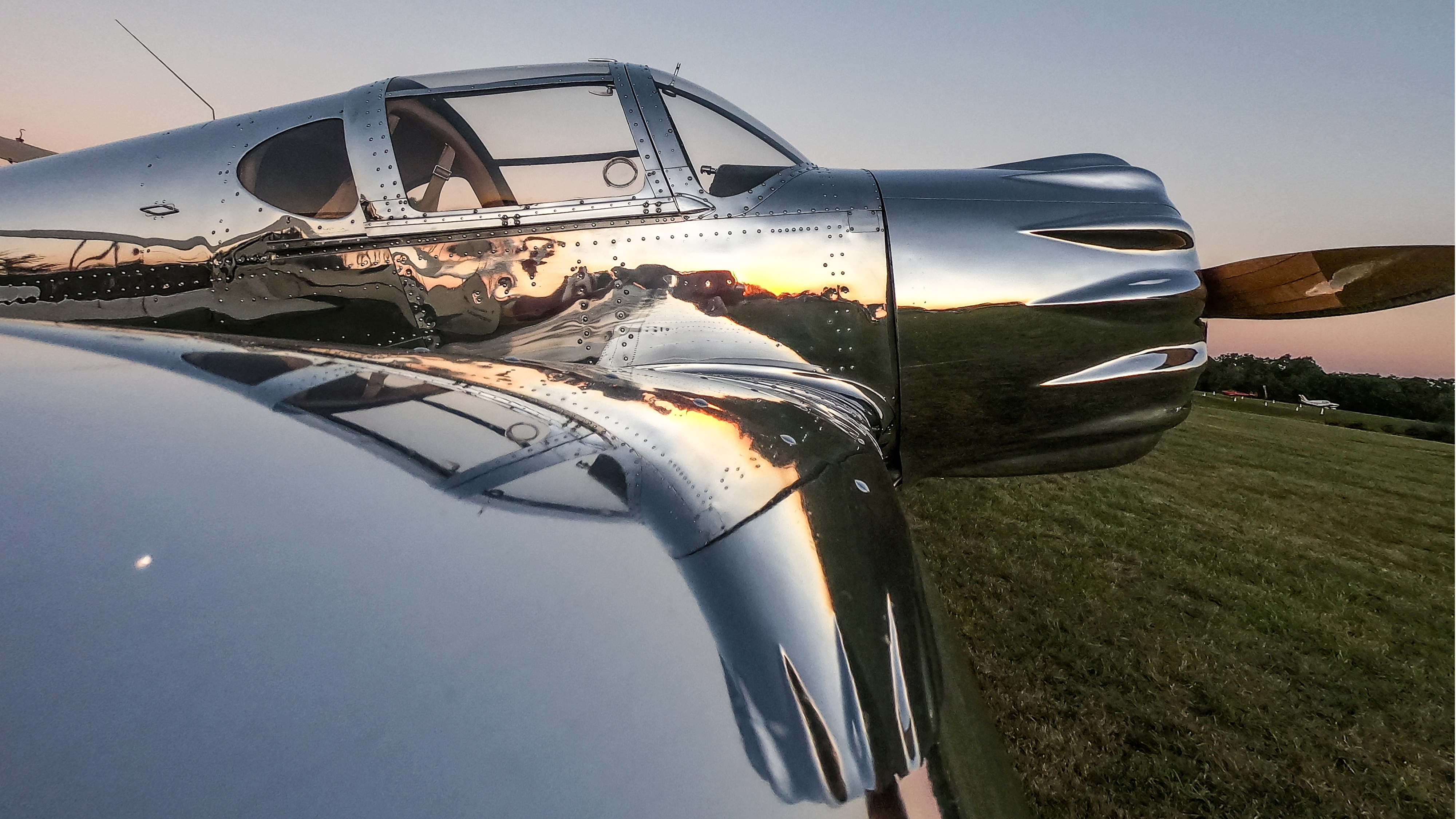 The sunlight reflects off a 1938 Ryan SCW.