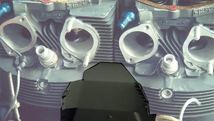 Intercylinder baffles are oddly-shaped pieces of sheet metal that mount beneath and between the cylinders, and force the down-flowing cooling air to wrap around and cool the bottom of the cylinders. 