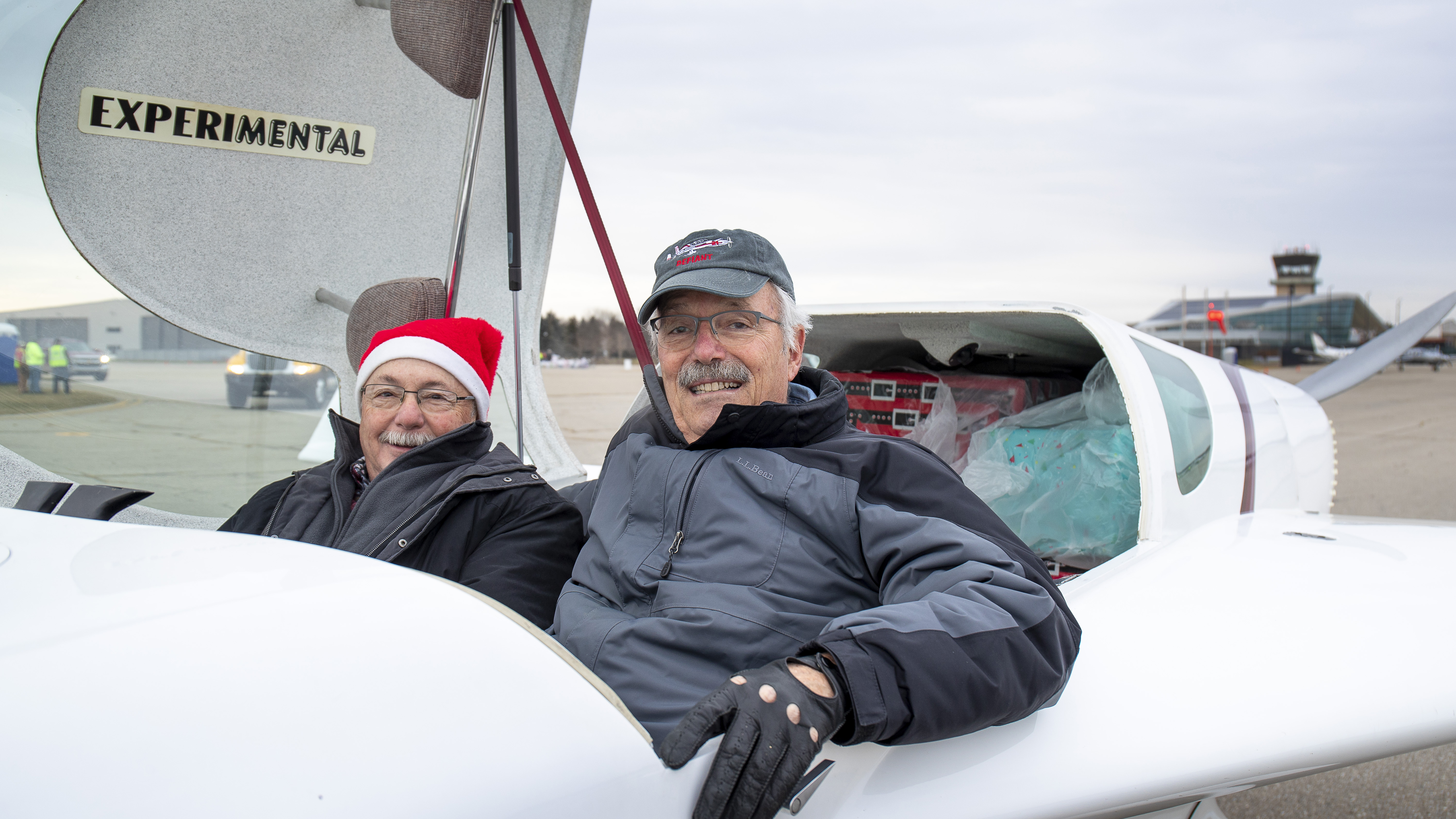 Curt Martin (in Santa hat) and Harry Manvel in an experimental Rutan Defiant.
