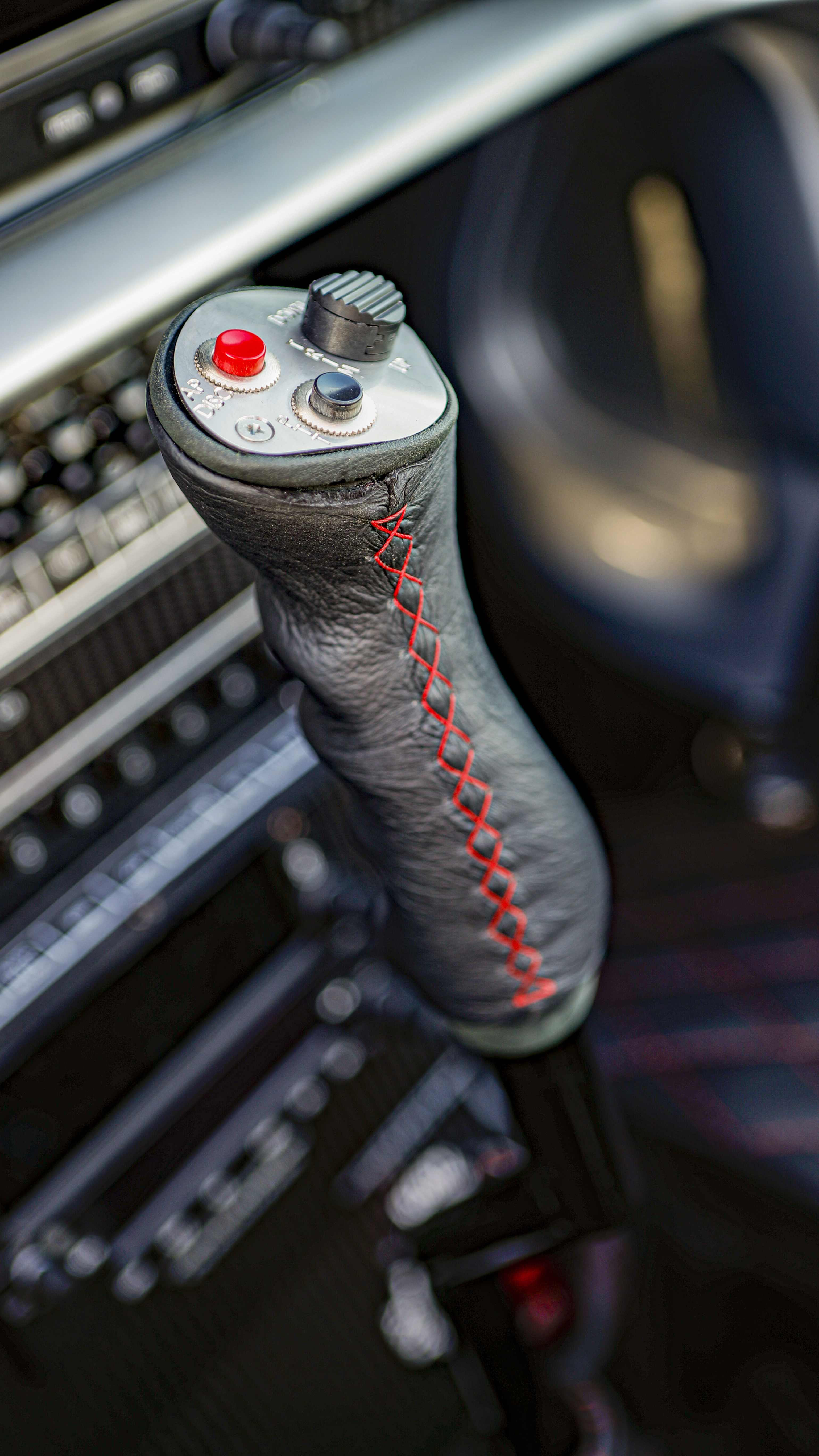 The floor-mounted control stick has a handle wrapped in leather.