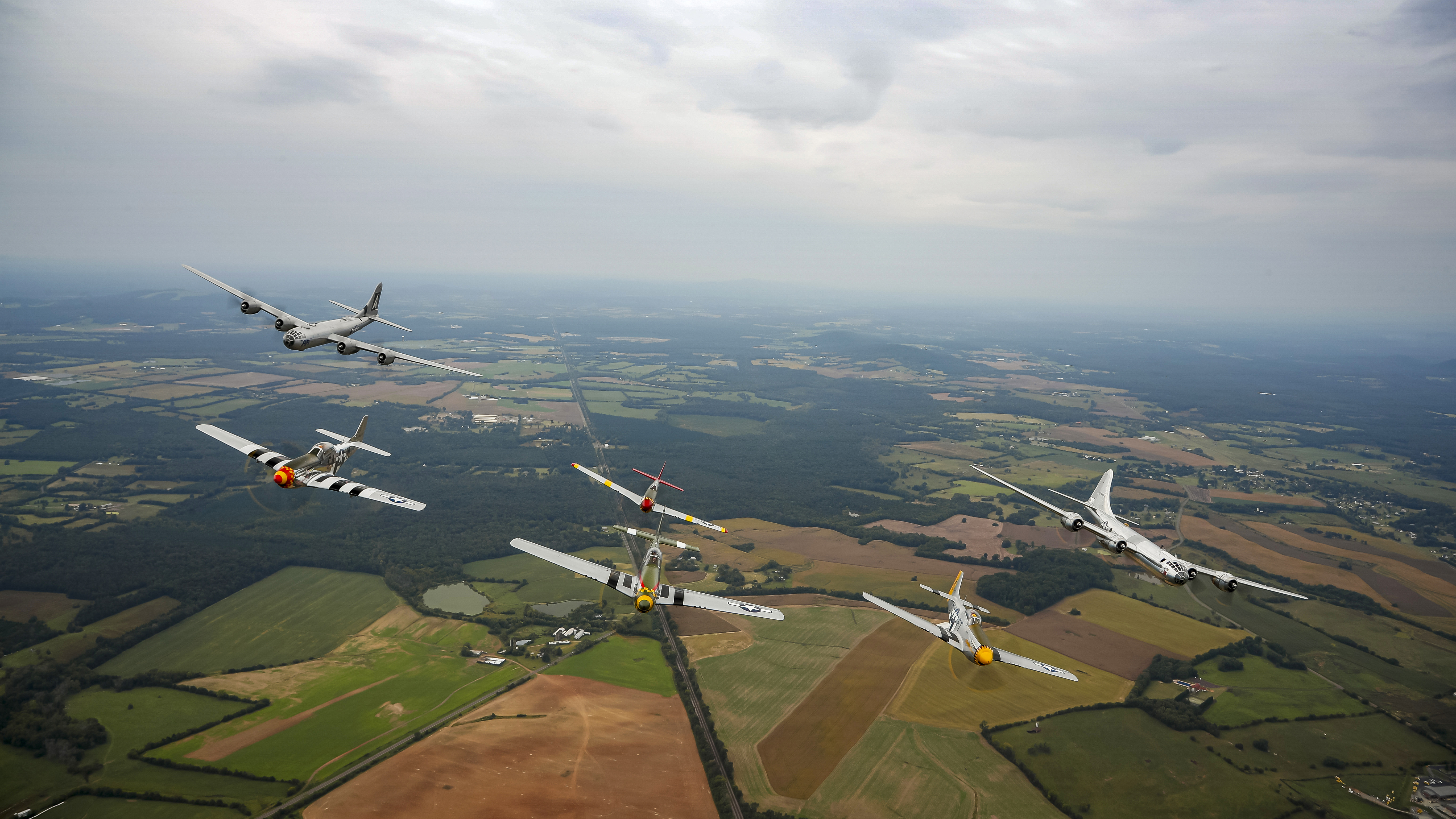 P–51 Mustangs fly with B–29s, which some escorted during World War II.