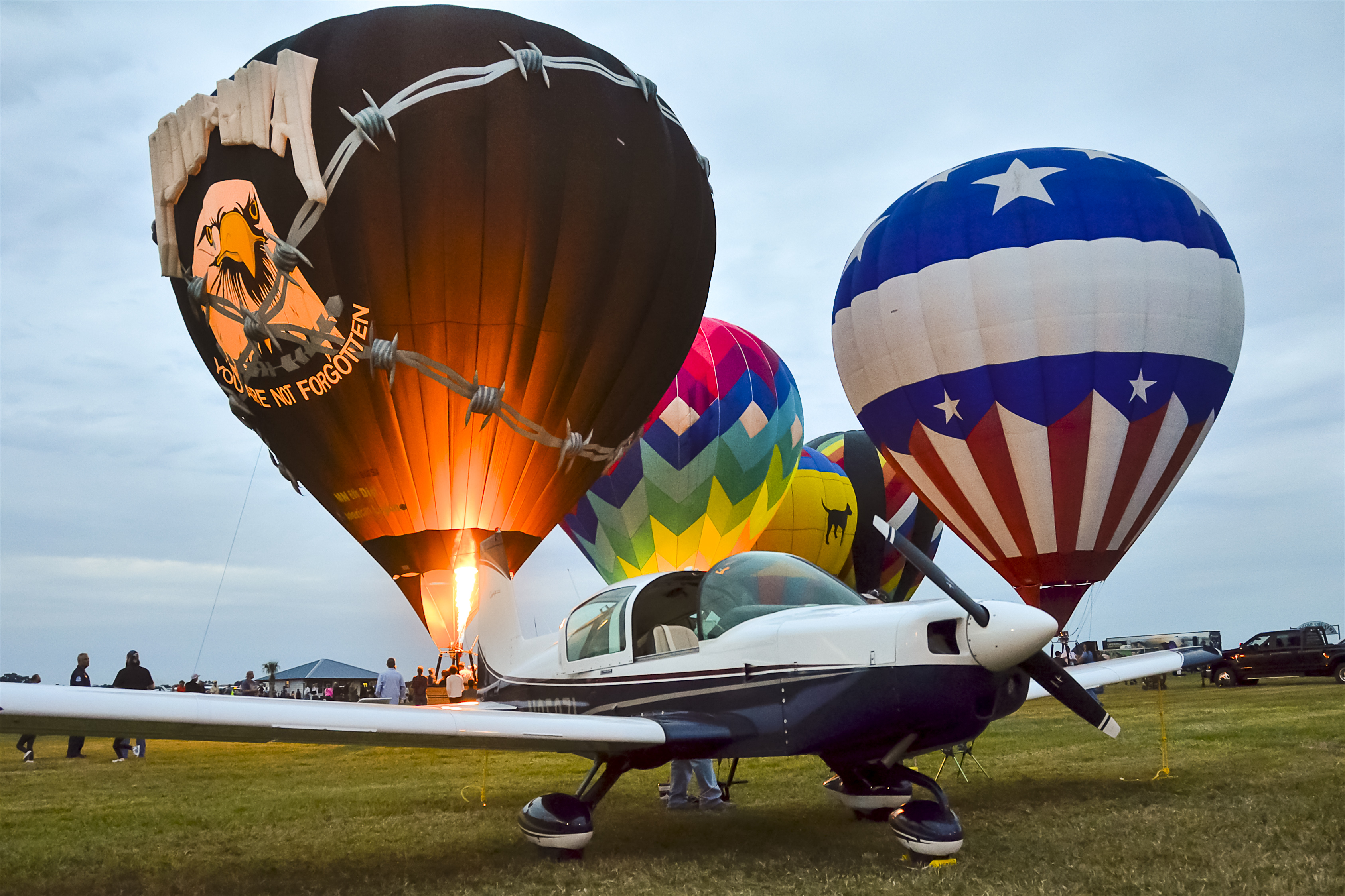 The Friday evening airshow was capped off with a balloon glow. The balloons framed a 1974 Grumman Traveler belonging to AOPA member Robert Wiles of Gulfport, Mississippi.