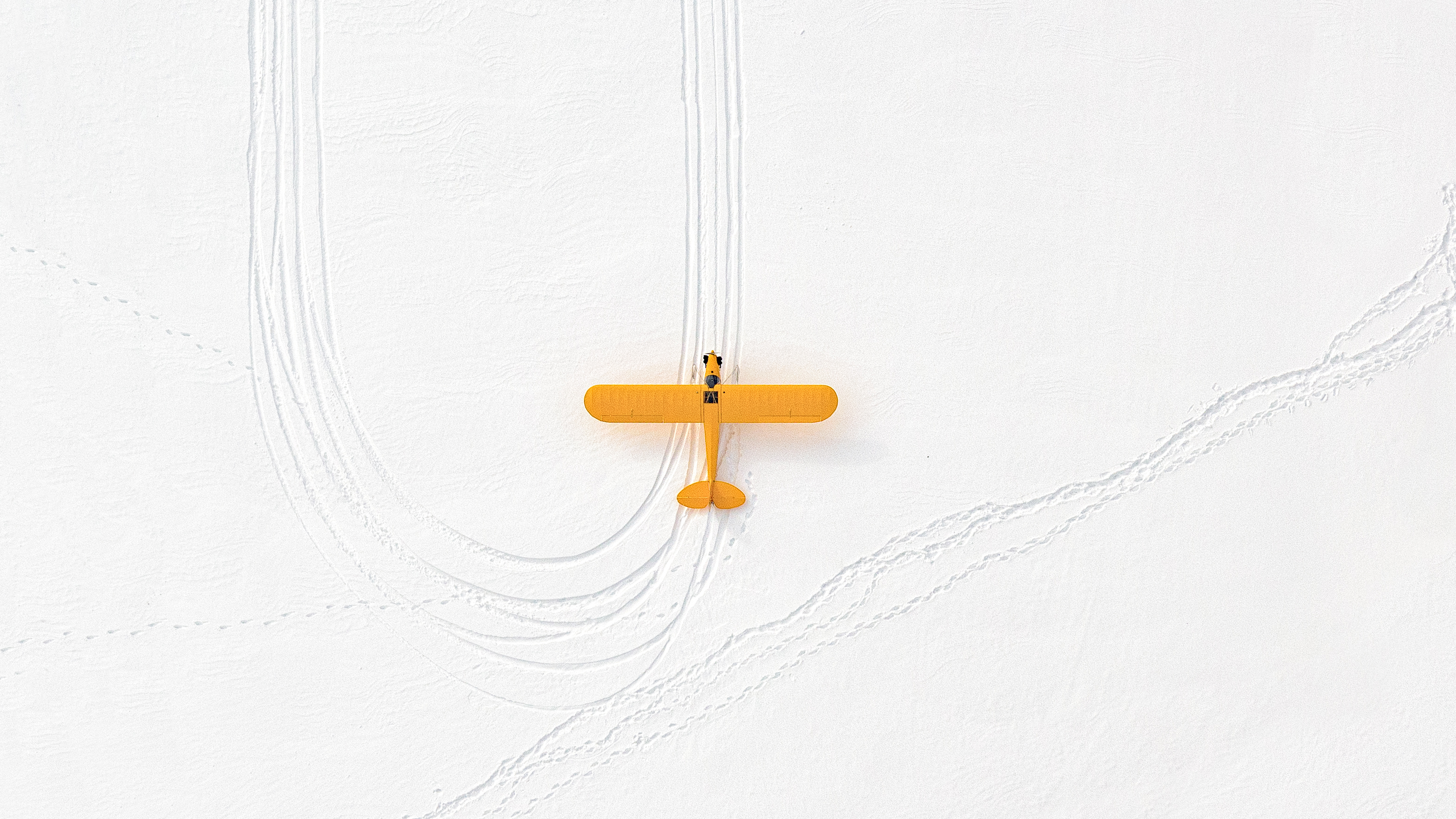 “The Winter from Above series is the result of passion, commitment, love of flying, and photography. For an experienced pilot and an accomplished photographer, this marriage is a natural way of expressing the beauty of the world as seen from above. It is also the appreciation of the simplicity and the elegance of nature. It offers a unique way to look at common things from a different perspective.”
“Yellow Plane”  was shot near Sky Manor Airport in Pennsylvania.