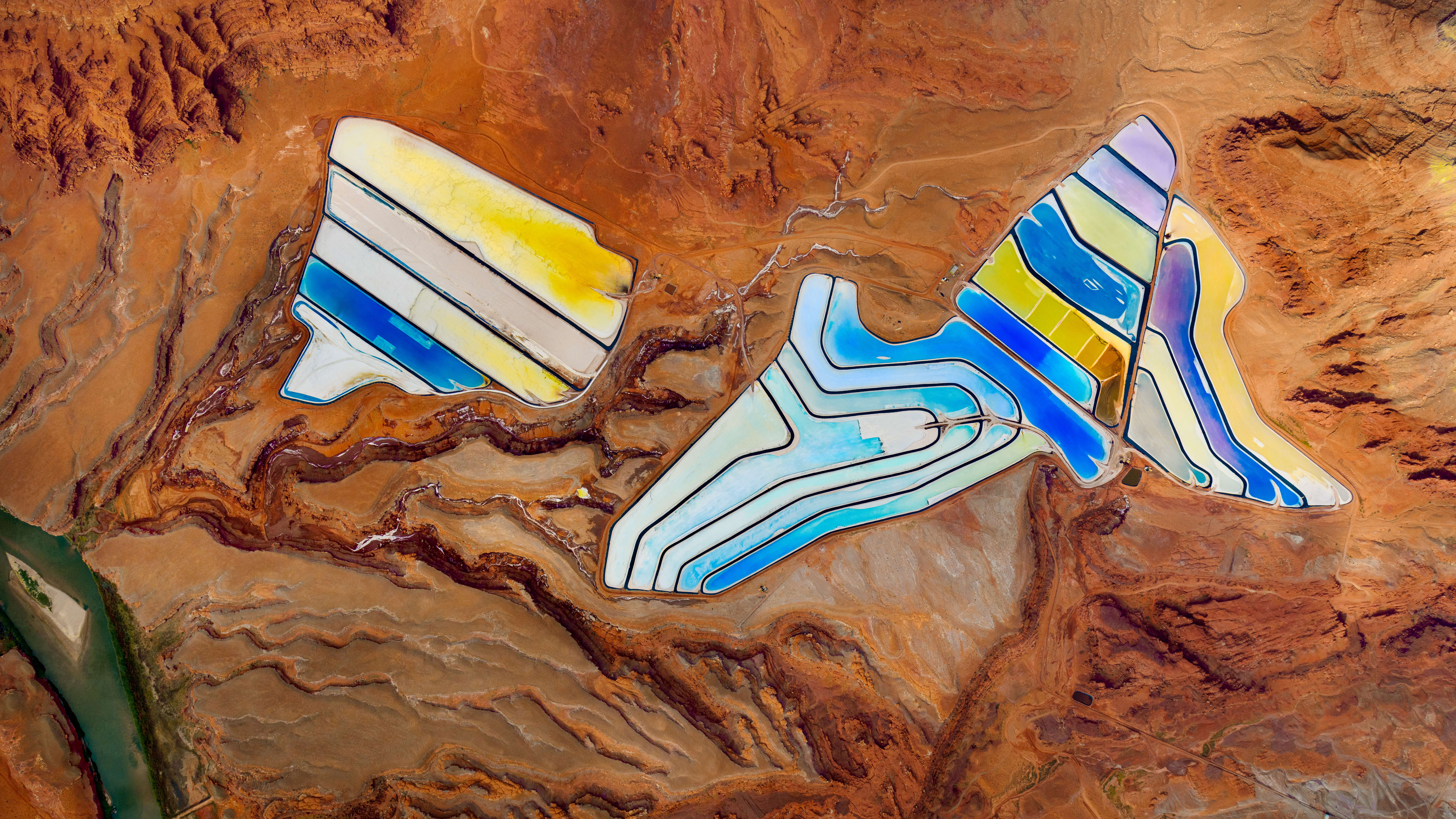 “The most notable thing on this flight were the salt lakes—these were similar, evaporation pools meant to extract minerals from the waters. They were brilliant blue and soft, buttery turquoise pools gridded out in the red rocks of Moab. Truly looked like someone had taken a paint brush and run it across the ground. Stunning and strange, we flew in varying altitudes above it, until fuel called and we landed at Canyonland.”
Potash mines near Moab, Utah.