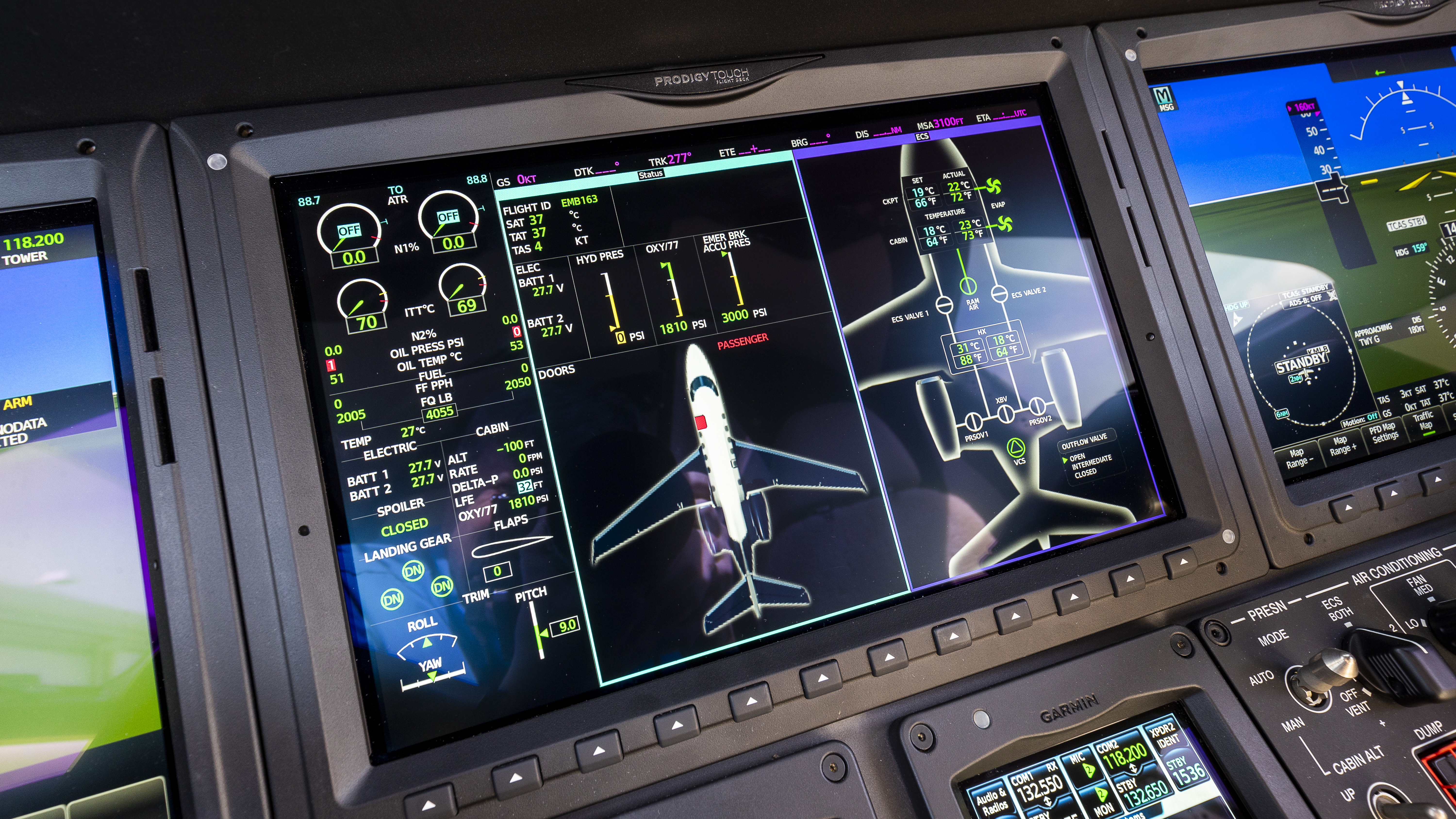 The MFD in Howley’s Phenom 300E is set up to show the airplane’s environmental system, an annunciator alert shows that the cabin door is open.