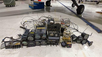 Out with the old avionics, instruments, and wiring—all to be replaced with digital avionics and instrumentation. The bundle on the floor weighed 62 pounds; the wiring alone weighed 12 pounds. The vacuum system also will be removed.