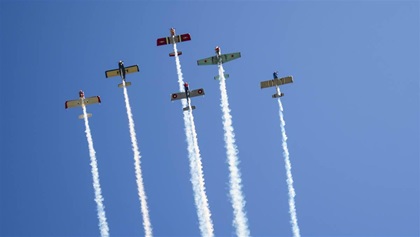 A six-airplane "Delta" formation is customary for Bandit stadium overflights, although the group sometimes adjusts that number up or down. Here, the formation consists of five RVs and a Yak 52. Photo by Mark Herboth Sr.
