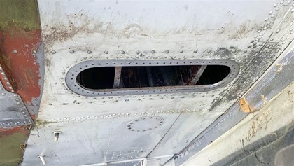 Inspection holes like this one (on the bottom of the right wing) provide the only access for technicians to make fuel tank repairs—and confined spaces make the laborious work especially difficult.
