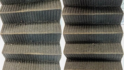 The oil filter media contained a small number of metallic flakes that were non-magnetic and had a yellowish appearance.