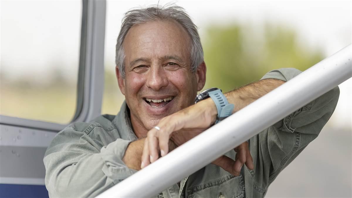 Peter Heller, author and pilot, with his 1956 Cessna 182 at Erie Airpark.