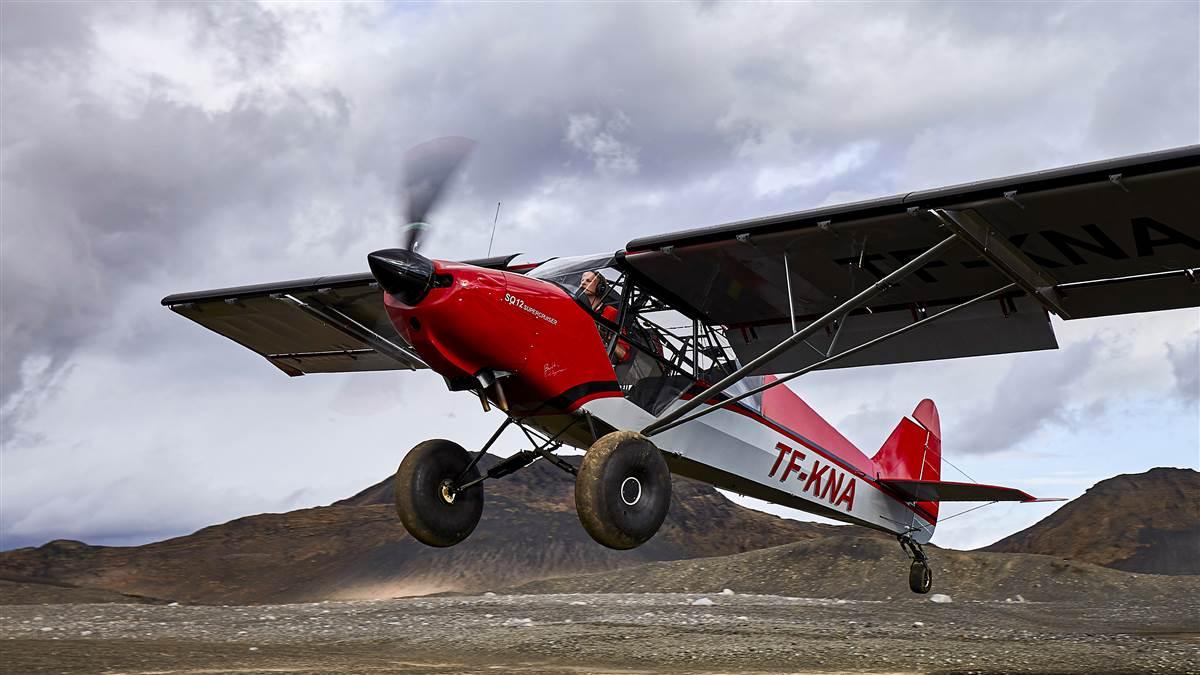 Photography of a Backcountry Super Cruiser SQ-12, flown by Arnar Emilsson, and a Piper Cub, flown by Thomas Joehnk, taking off and landing next to a glacial stream.

Langjokull Glacier
Reykjavick Western Highlands Iceland