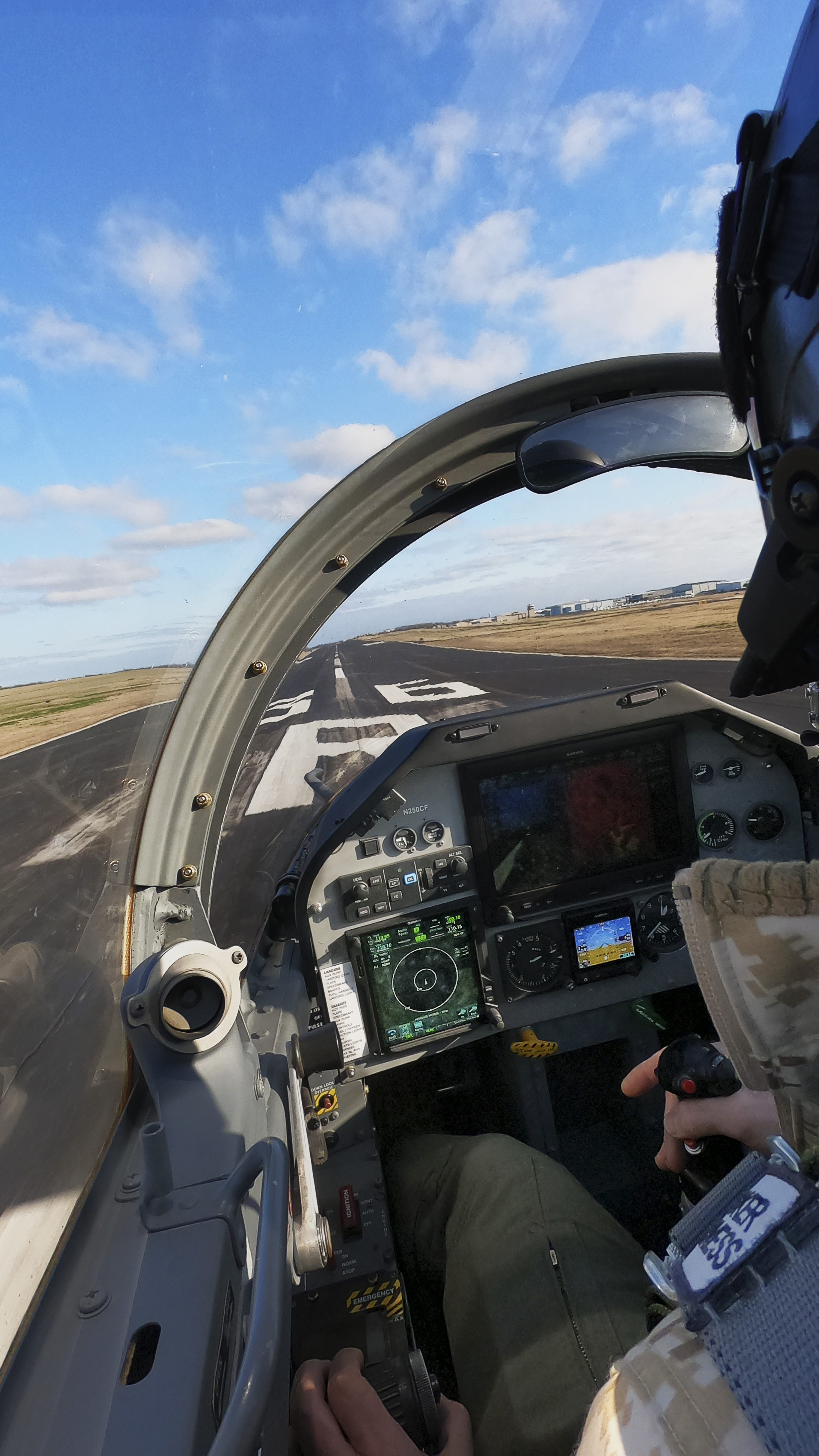 An over-the-shoulder view of the runway shows how close the pilots sit to the white stripe.