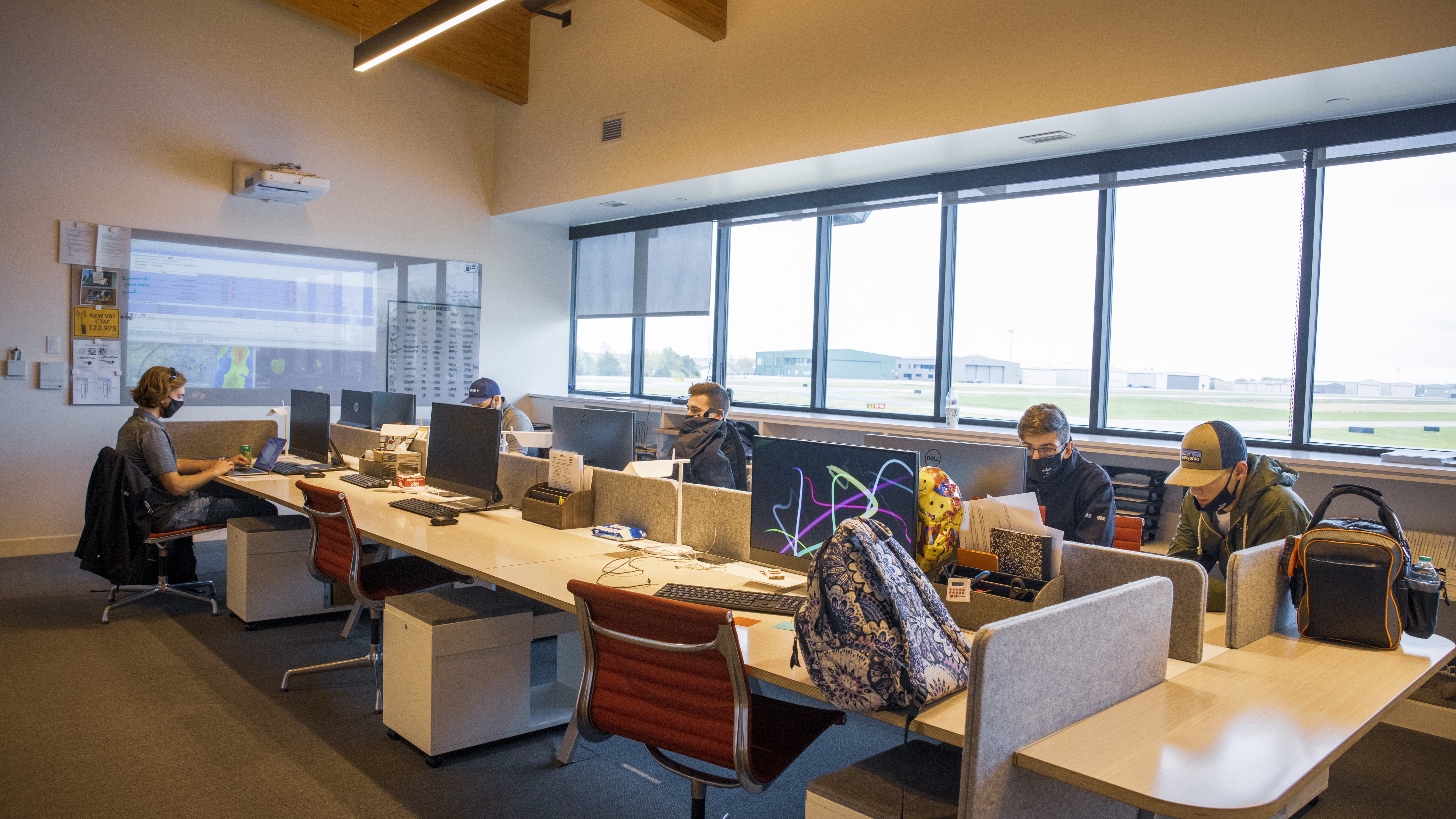 Students prepare for instruction in the flight school study area.