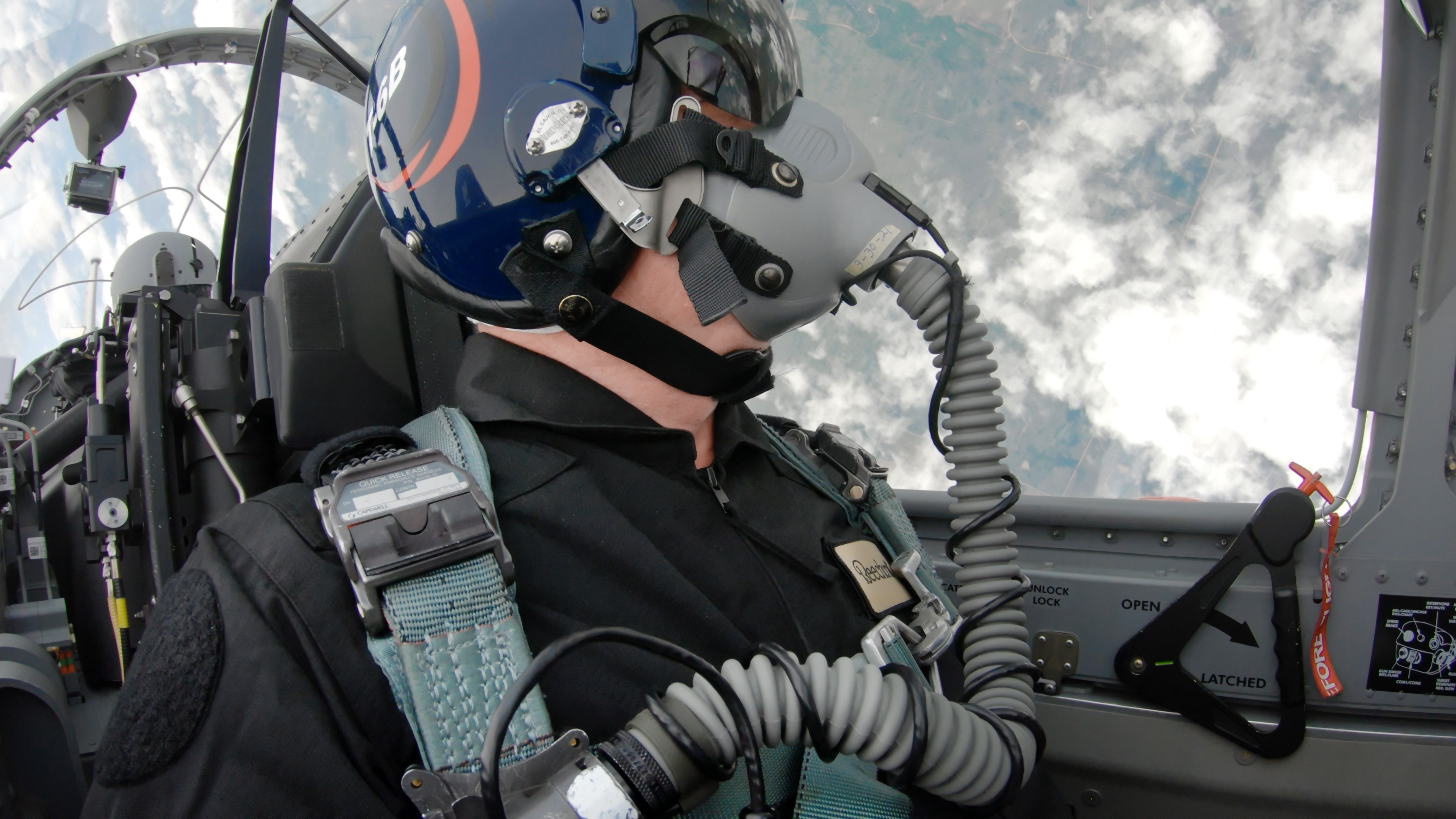 The author, somewhere over Kansas, in mid-roll. The red clevis pin in the door handle is a reminder that the ejection seat is armed.