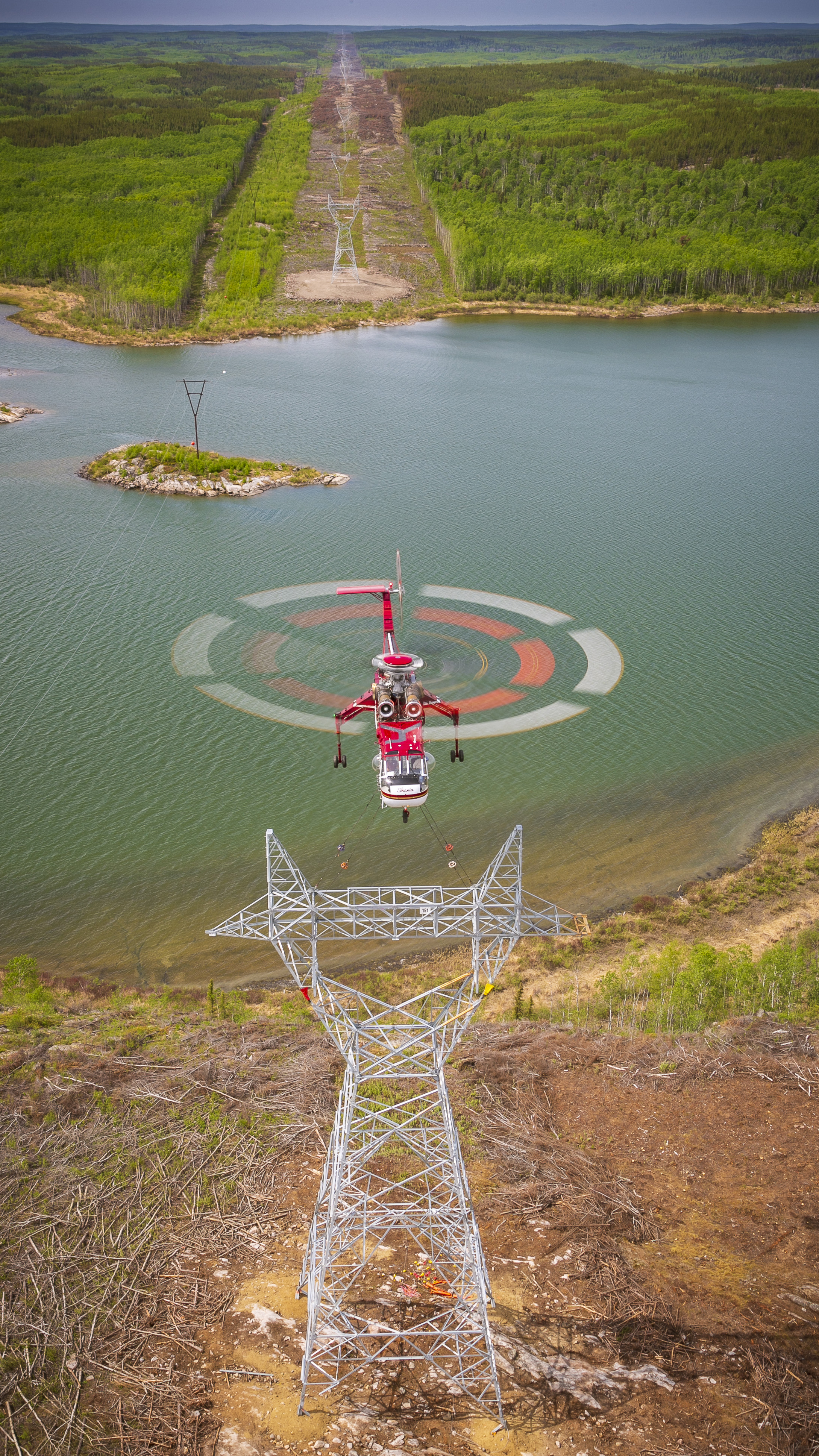 Shooting a full rotor disc in flight is difficult. Moffatt was able to pull it off on a Skycrane, shooting one-twentieth of a second, using an Airbus H125 as a platform. "The company was installing 150 kilometers of high-tension power lines to go between a uranium mine and a hydroelectric dam. The Sikorsky Skycrane was the heavy lifter, and here it’s placing the upper portion of the tower into position. That requires lifting 12 tons of steel structure and setting it down with precision accuracy. The pilot and people handling the guy lines are trying to put an 8-inch pin into place. I wanted to show the size of the structure and the helicopter, with the lines going off into the distance.”