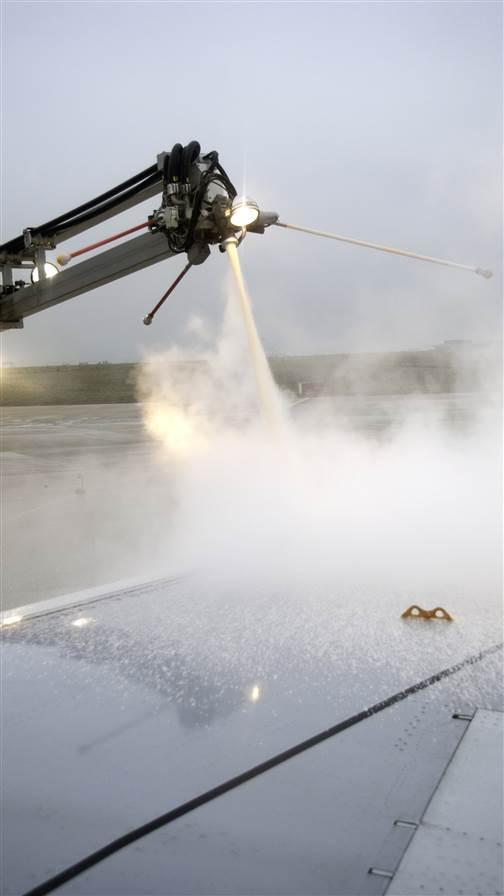 Preparing for takeoff: Airplane getting de-iced in Winter