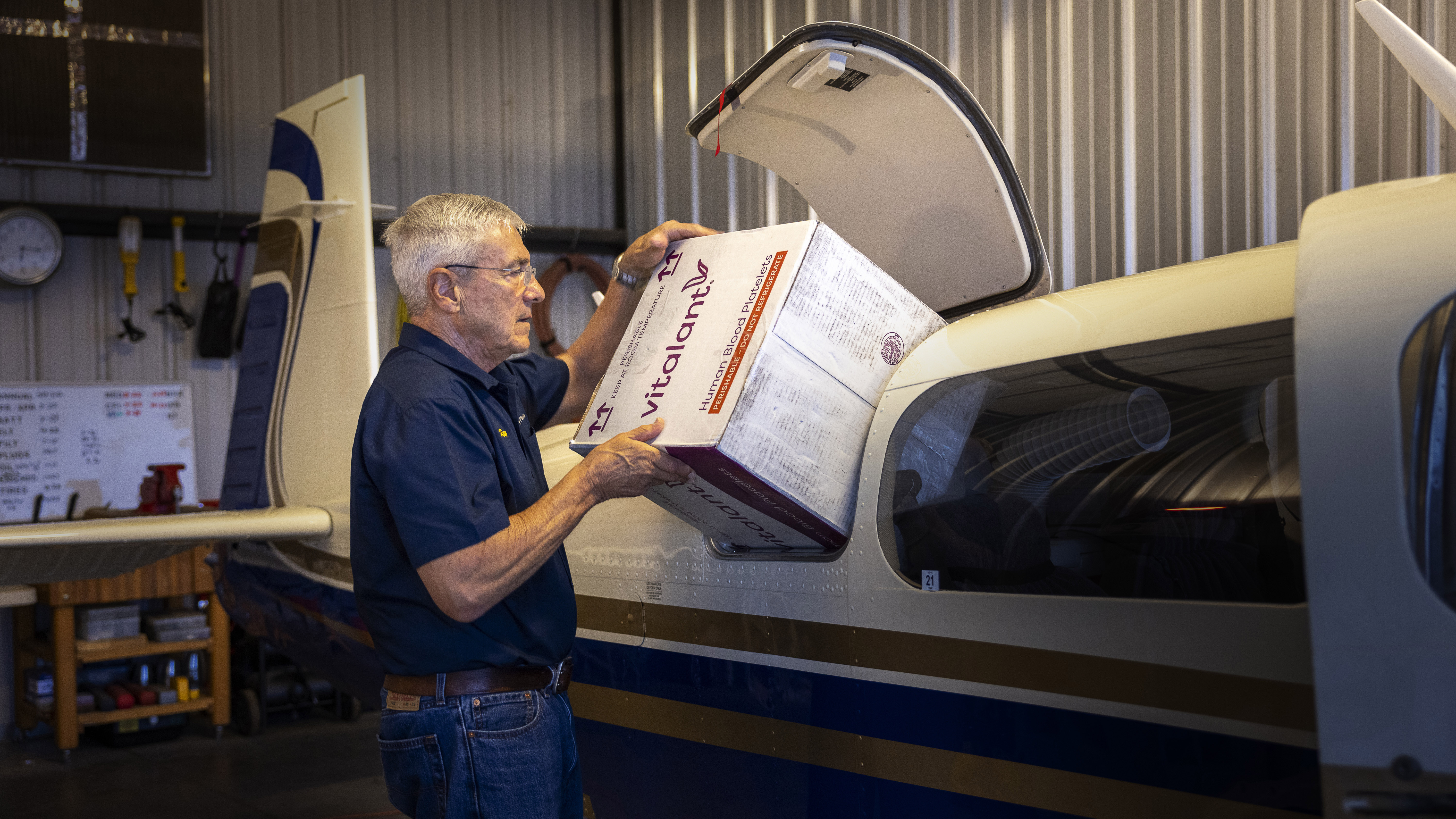 Volunteer pilot Ray Reher loads a box of blood products into his Mooney Ovation (below), headed for Flagstaff, Arizona.