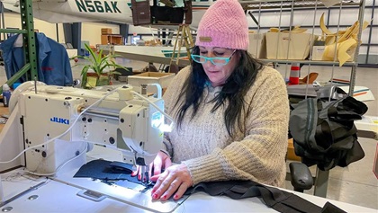 Seamstress Amy Mancha sews seat upholstery inside Oregon Aero’s airplane upgrade hangar. Like many of the company’s 60 employees, she’s been working there for years.