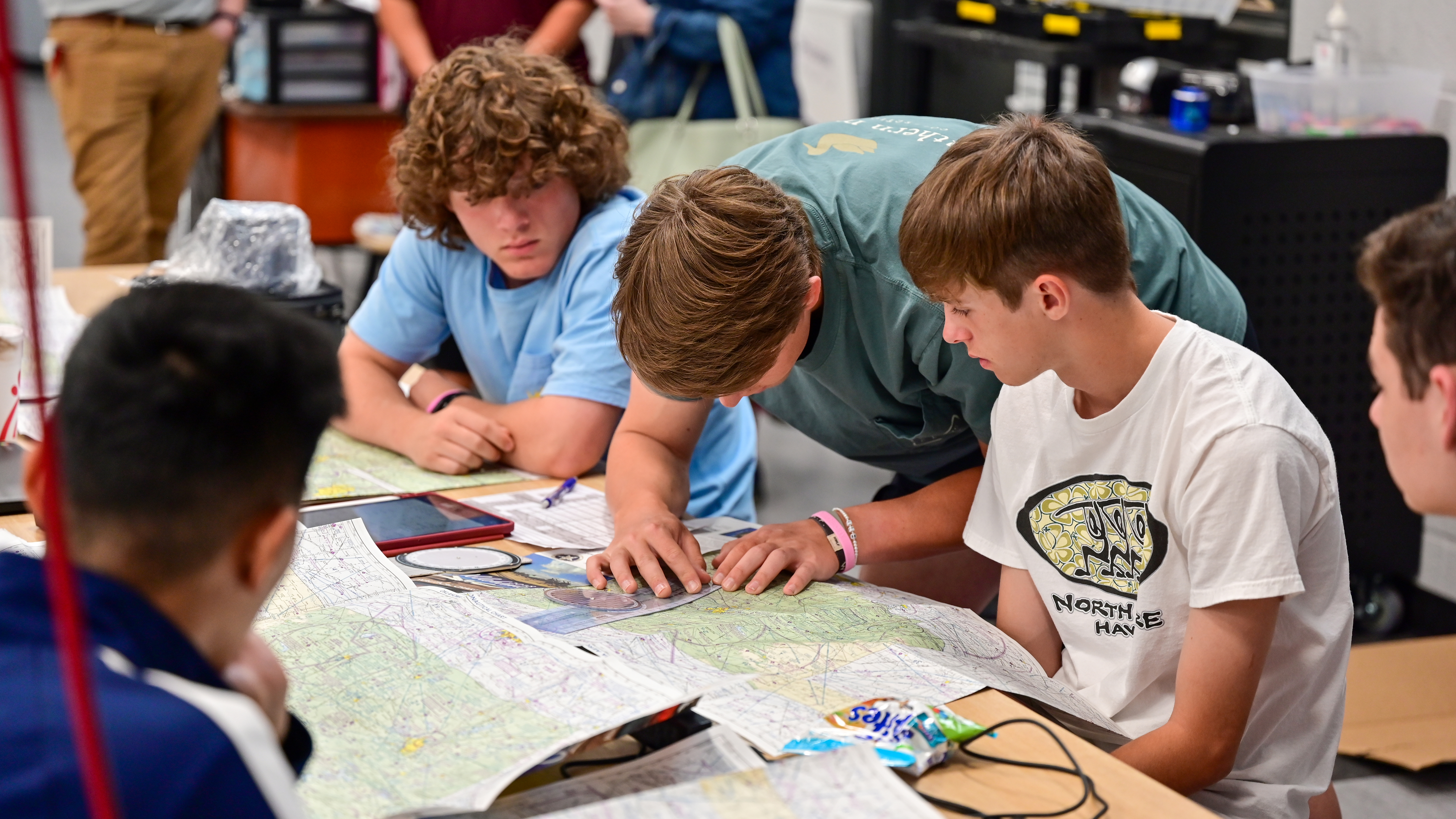 Ada High School seniors teach ninth-graders the basics of cross-country flight planning.