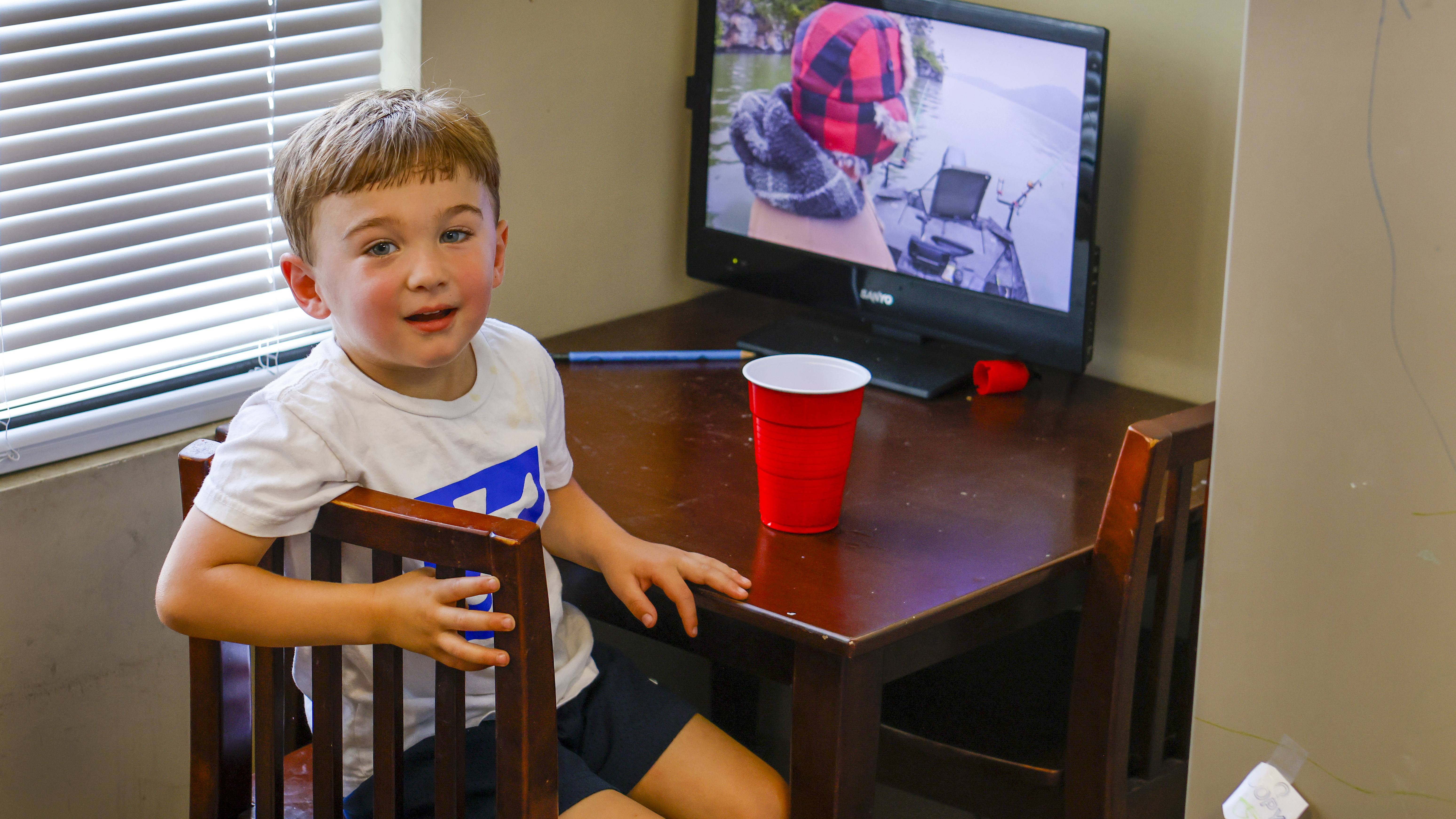 Buddy Charvet has his own desk in the Southern Seaplane office; he likes to watch fishing shows on his small television.
