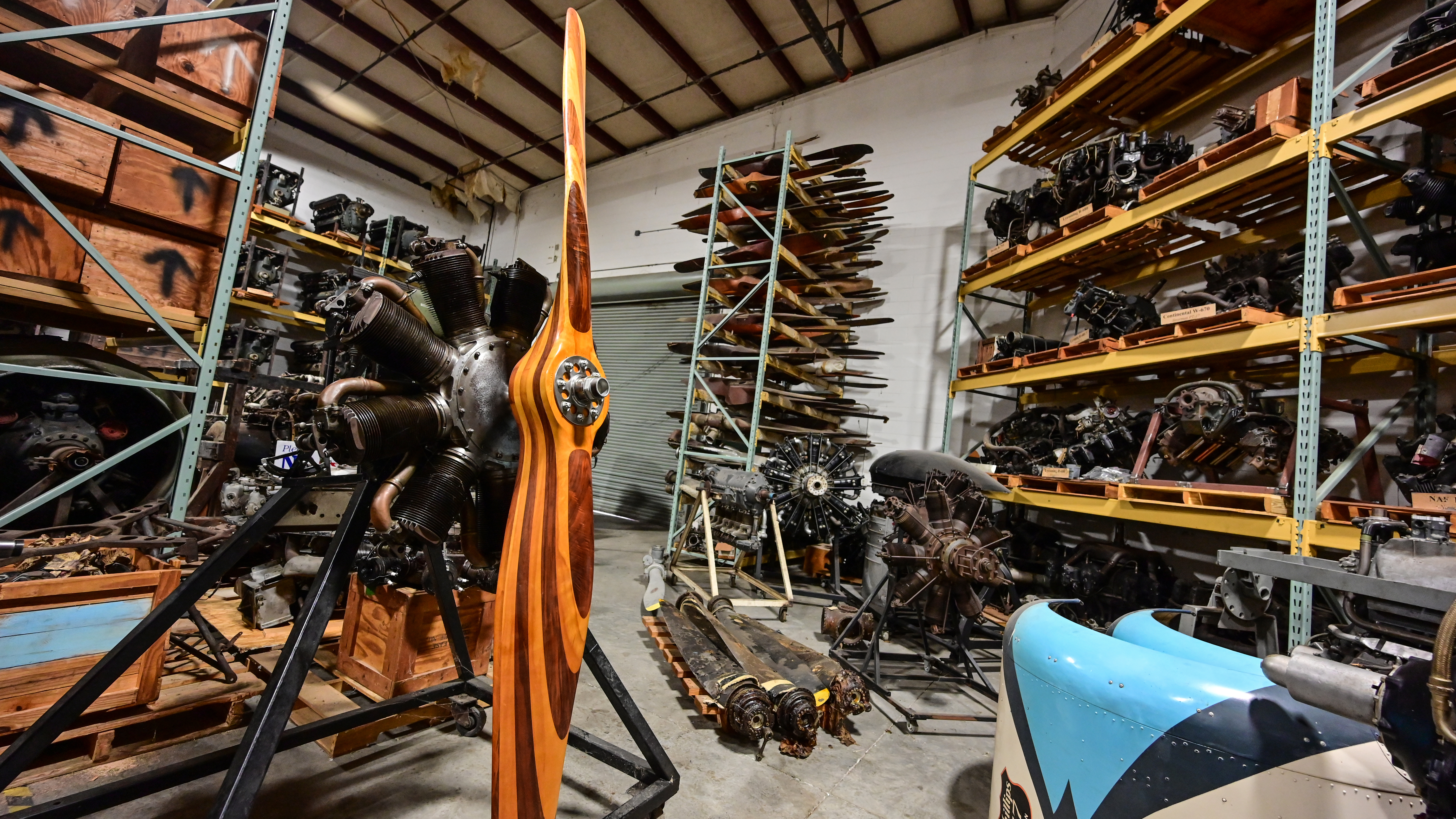 Propellers, engines, cowlings, parts and more parts are stacked floor to ceiling. Weeks says he keeps all of these for his private use in his own restorations.