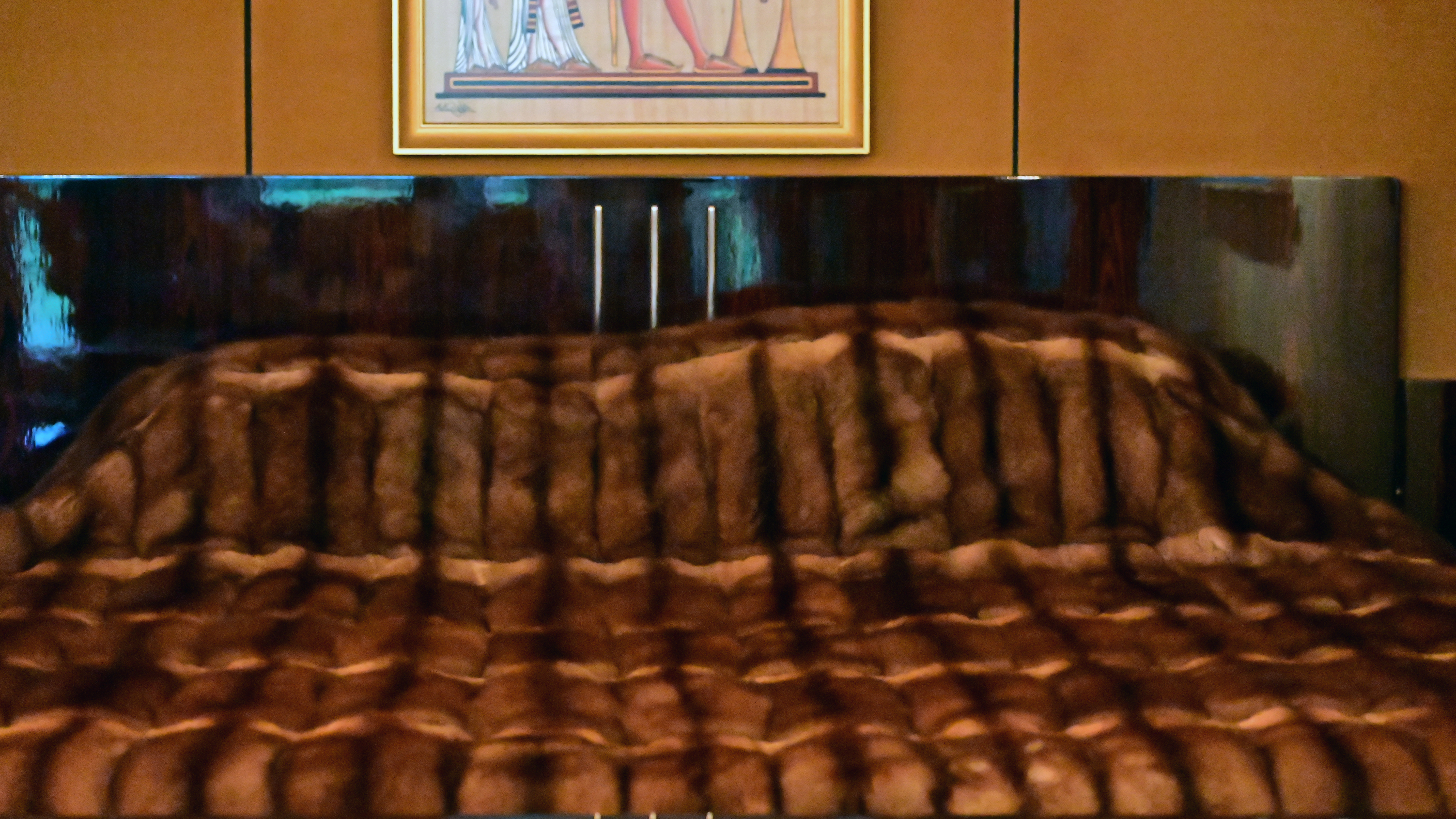 A bed on the second floor covered in a mink bedspread.