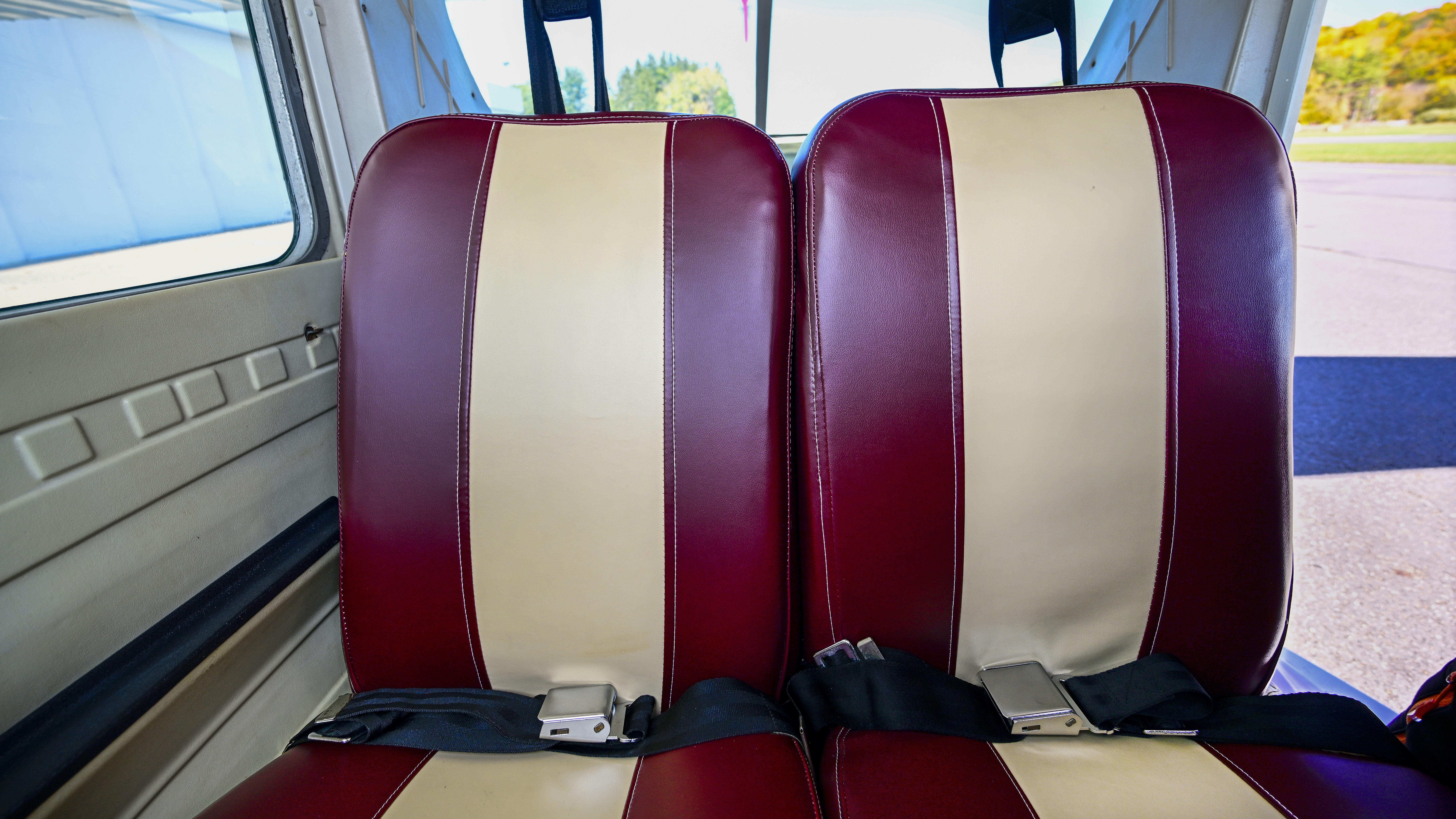 Custom-made burgundy and tan leather seats replace well-worn gray vinyl and fabric counterparts.