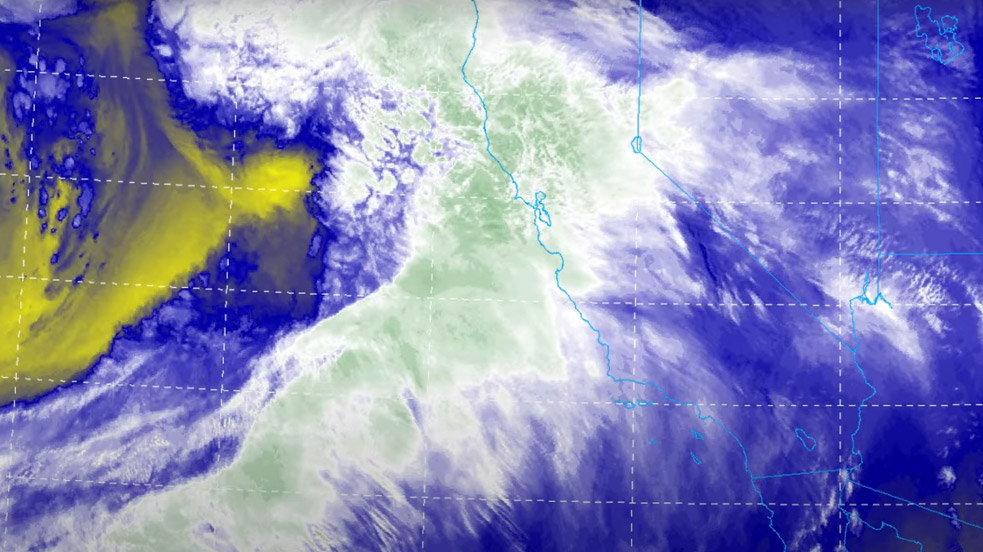 An enhanced satellite shot shows a "river's" landfall. Green indicates highest cloud tops; yellow is dry air being drawn into the low pressure system's circulation.