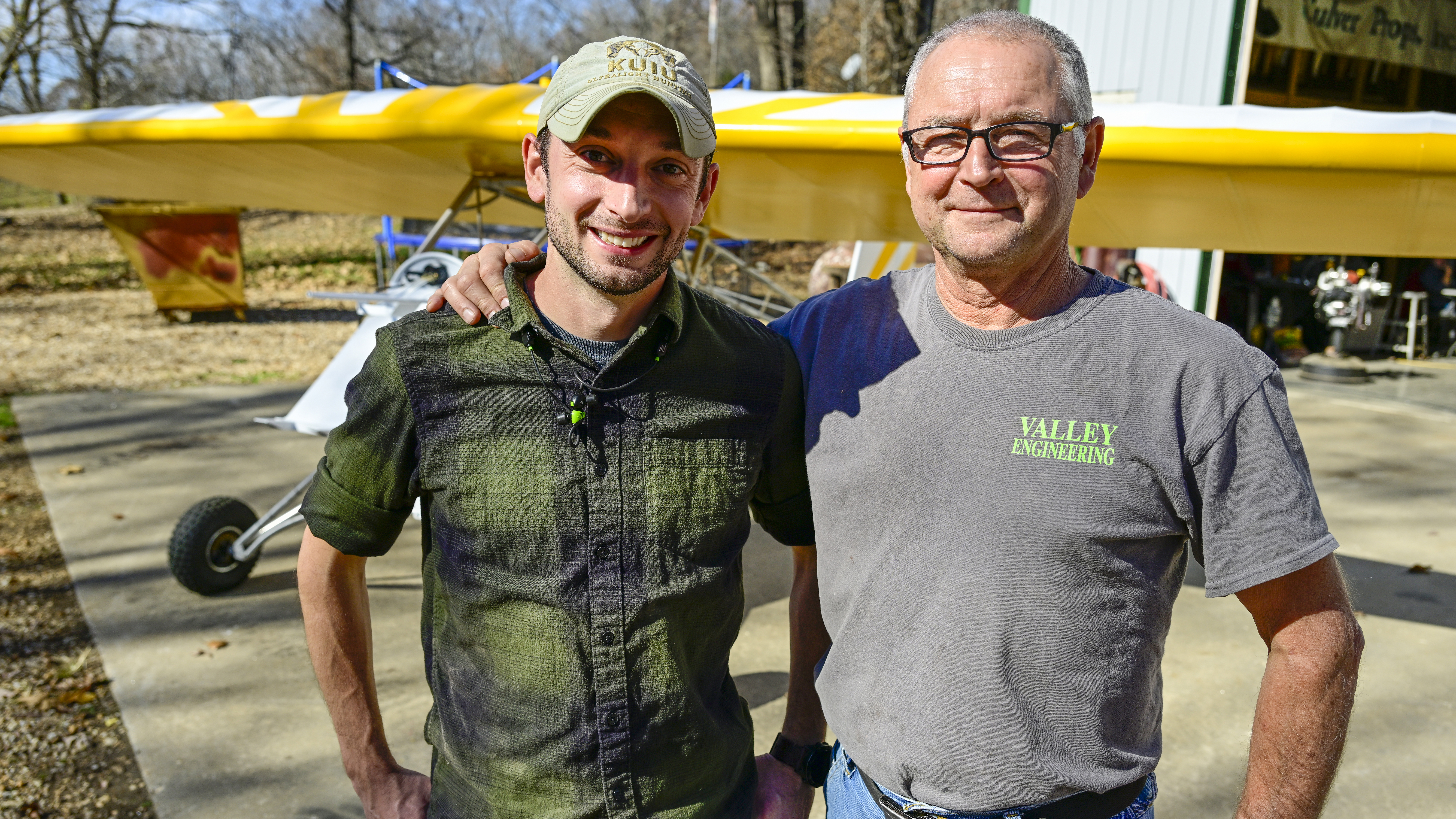 Grant Smith and Larry Smith in front of a Back Yard Flyer, designed by Larry's father Gene Smith.