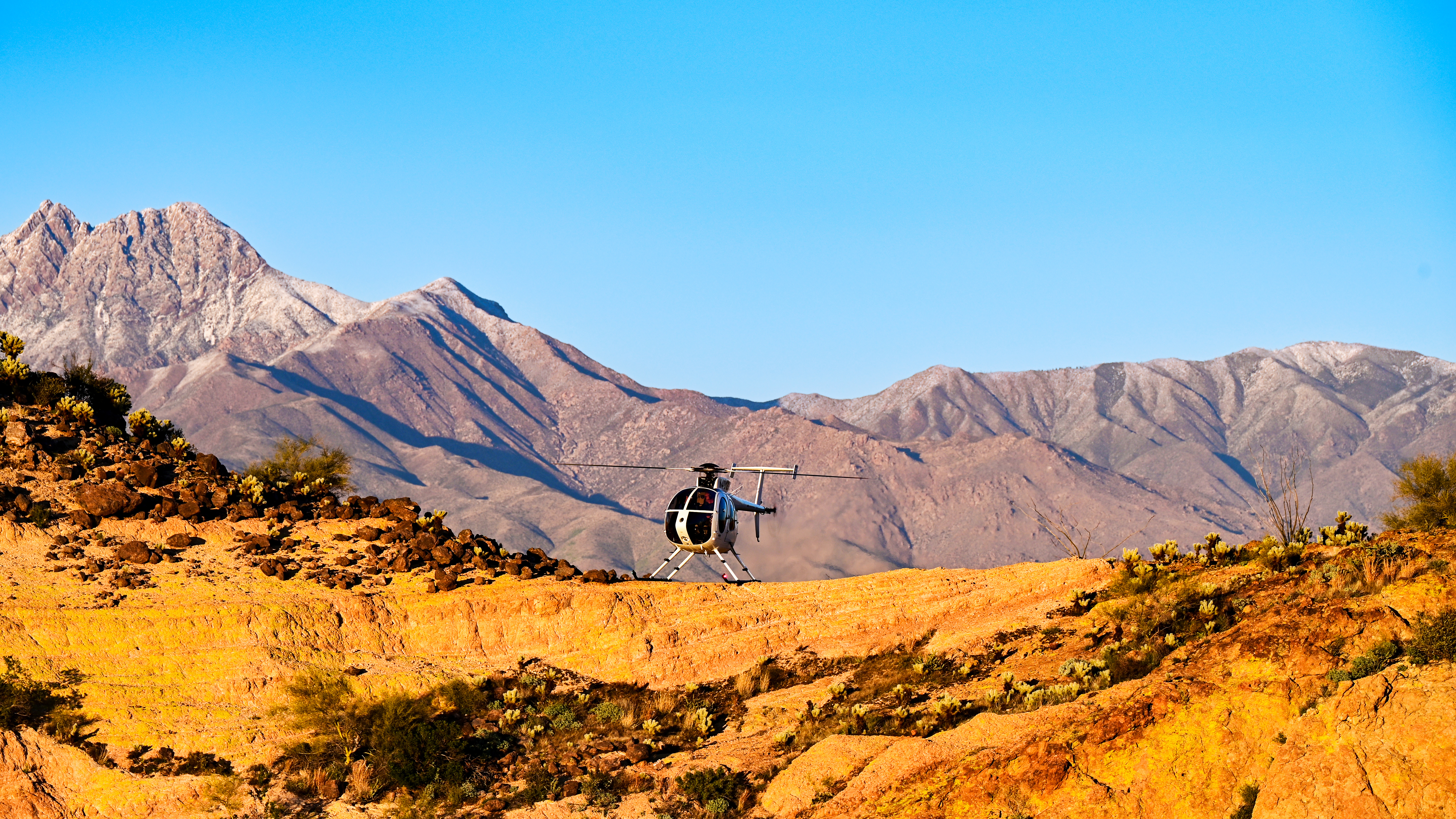 An MD Helicopters MD500E is framed by part of the Four Peaks Wilderness Area near the company’s Mesa, Arizona, factory.