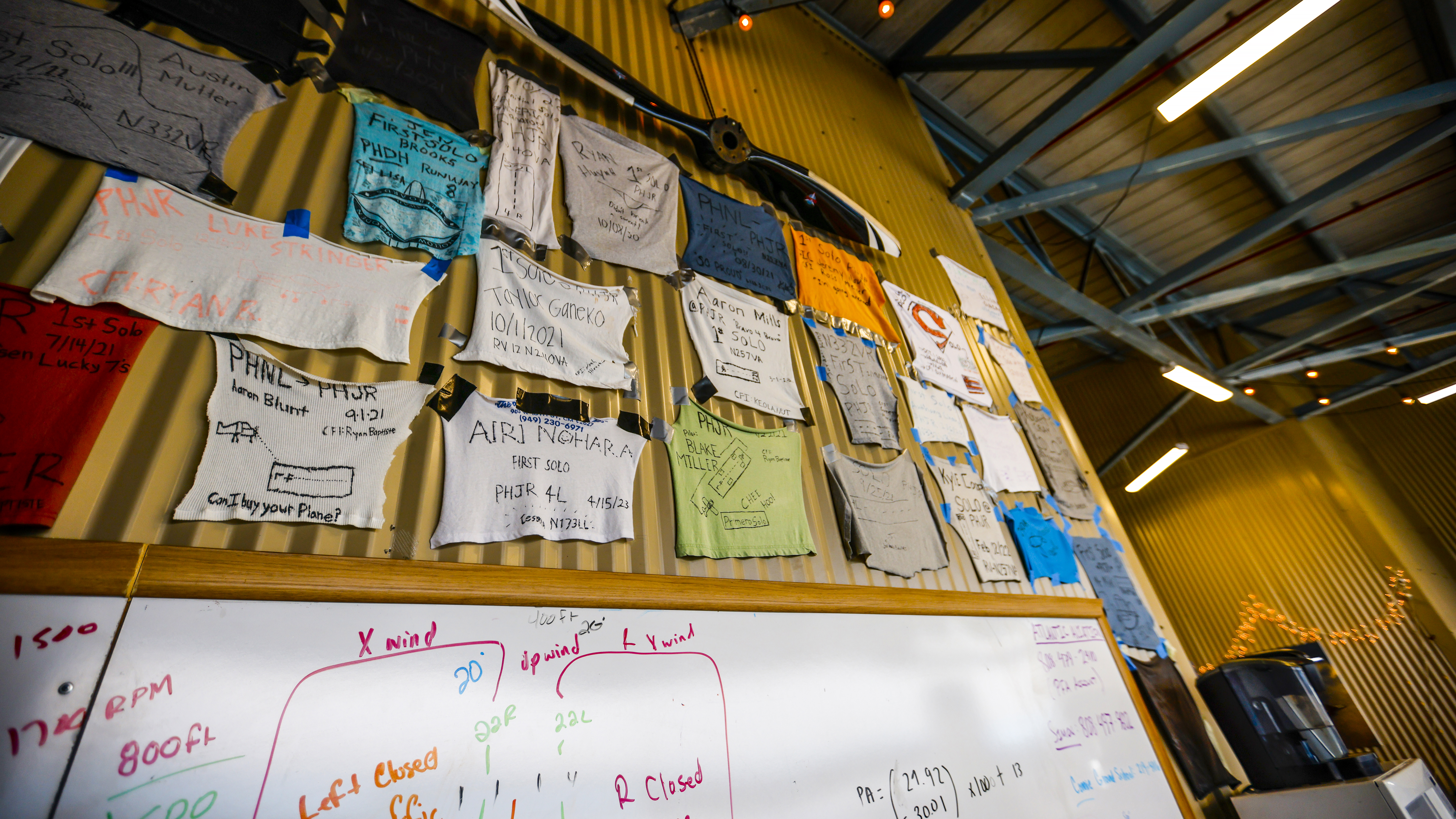 A staple of any flight school, solo shirts line the hangar walls.