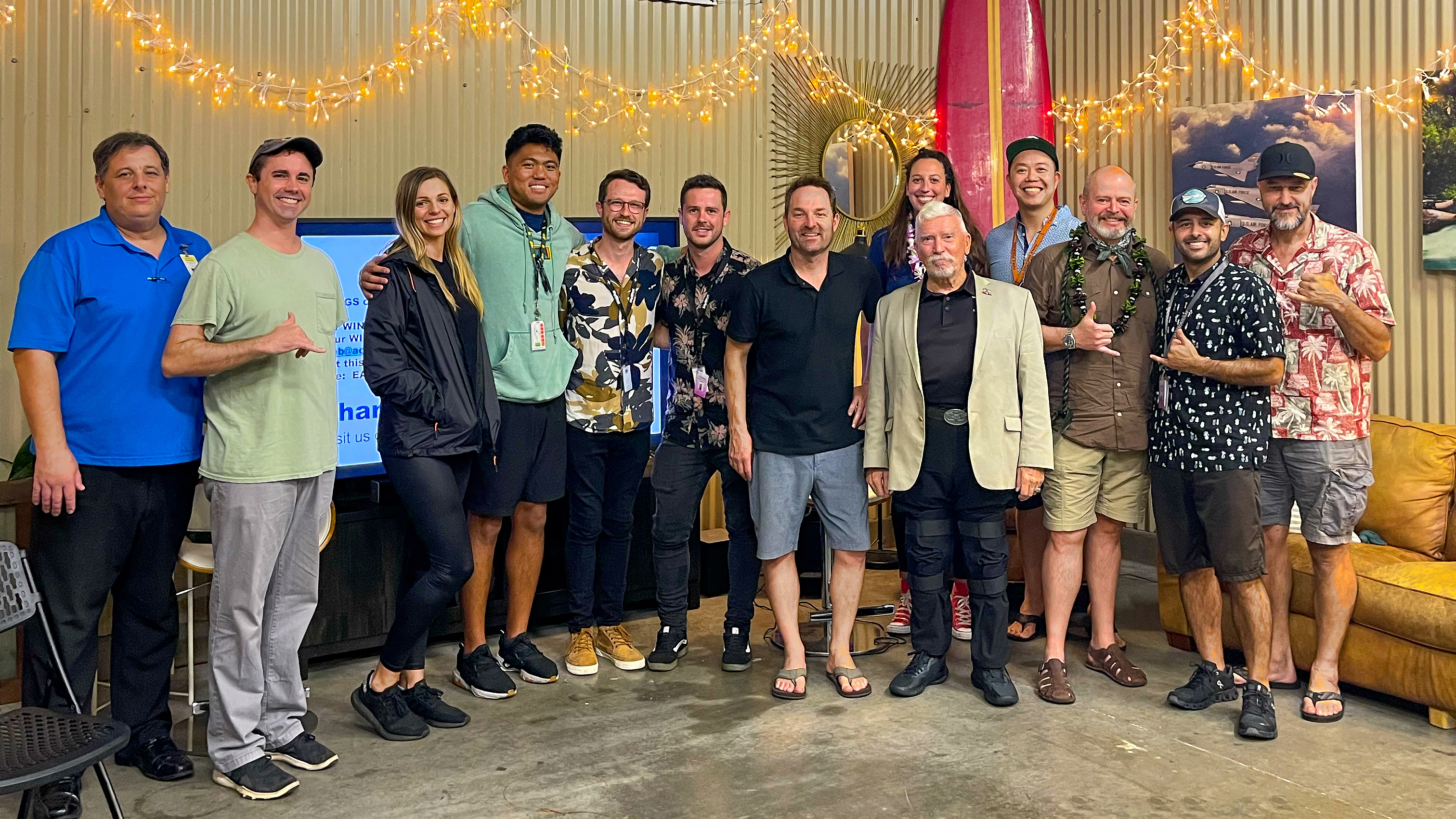 Some attendees of an AOPA safety seminar gather in the hangar for a photo.