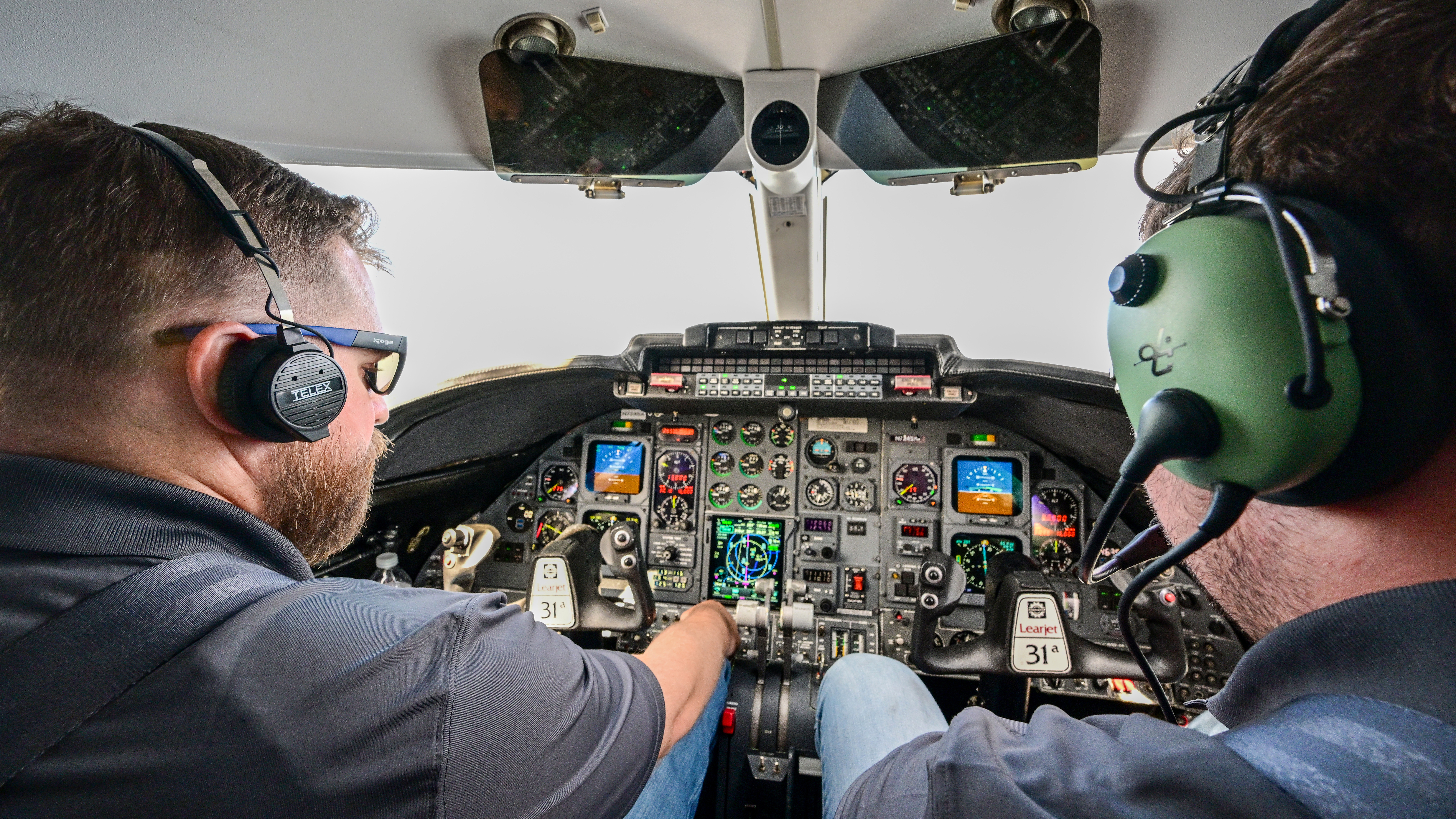 The tight Learjet 31A cockpit contains both modern and legacy avionics.