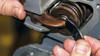 Measuring dry tappet clearance.