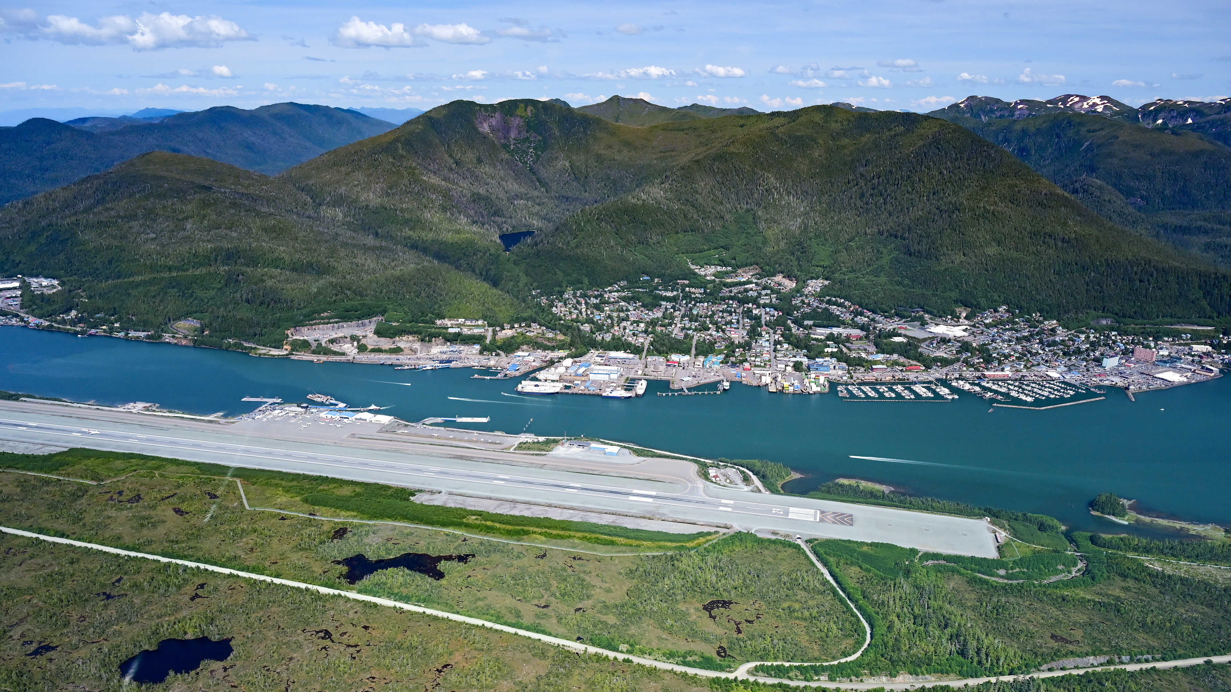A rare sunny summer day gives a clear view of the hard-surface runway at Ketchikan International Airport (PAKT) as well as the downtown waterway used by seaplanes and just about every imaginable type of boat and ship.