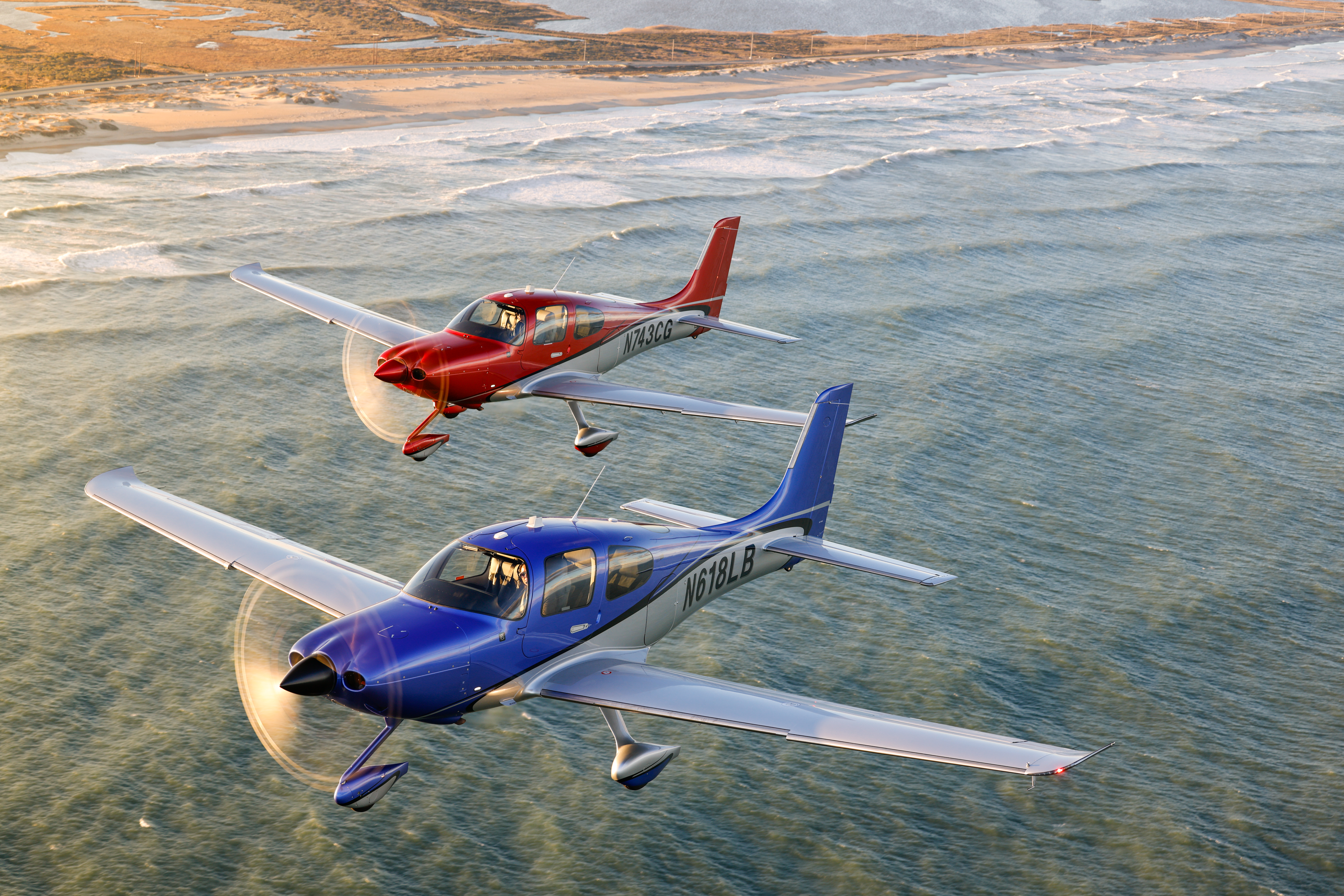 A pair of SR22T model G7s flying south along the Atlantic coastline of North Carolina. Photo by Chris Rose.