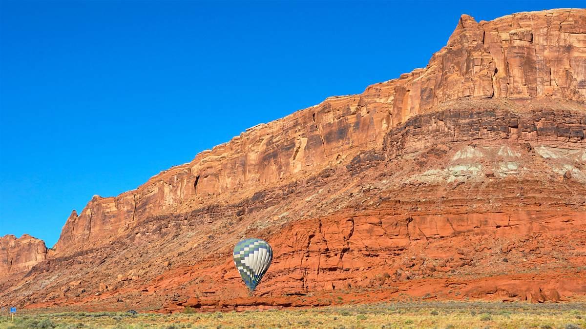 Hot air ballooning along Moab’s red rock cliffs. Photography by Sue Durio.