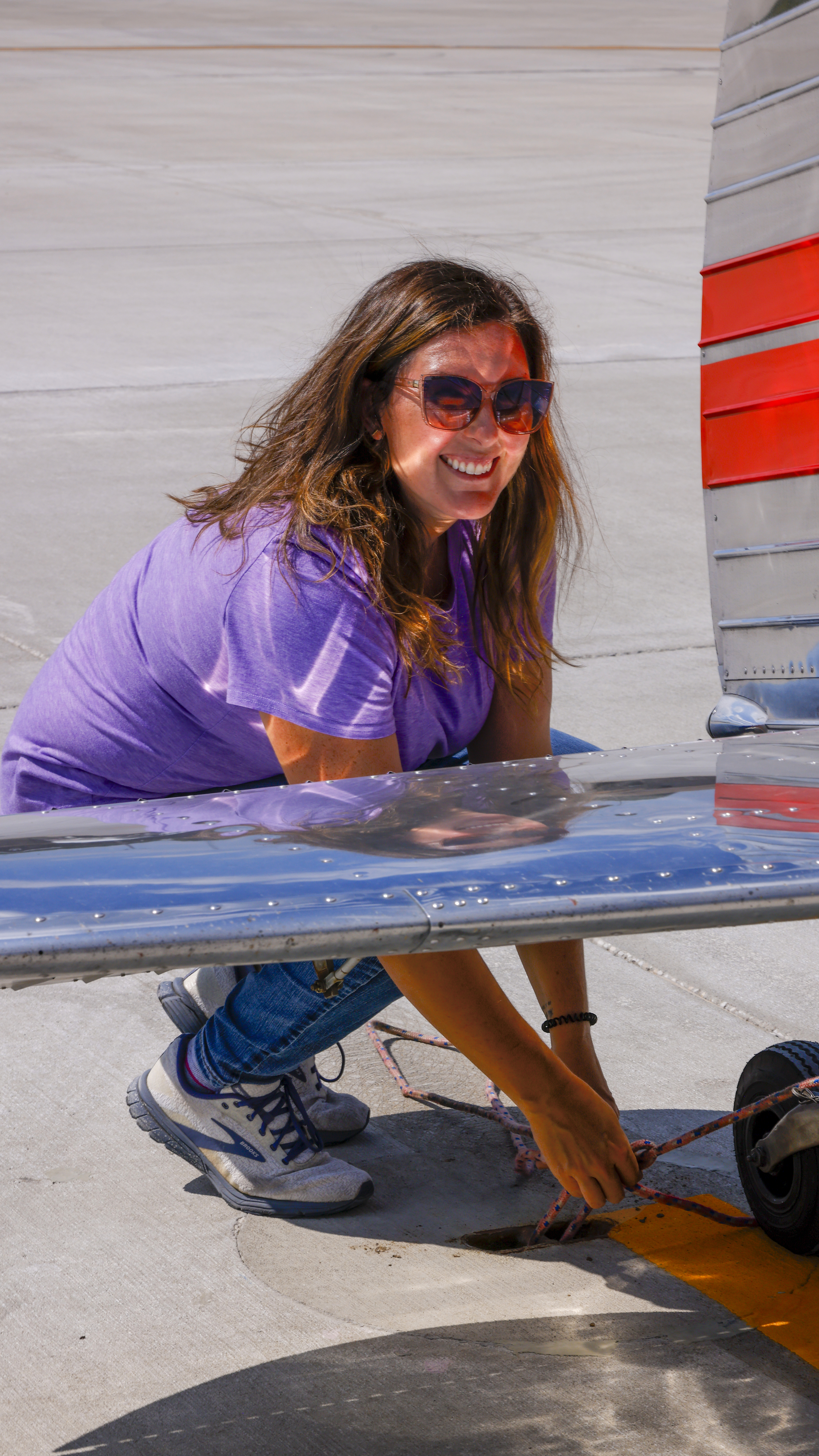 Laura Benton ties down her family’s Cessna 170 at Grand Glaize Airport, one of two general aviation airports that border the lake.