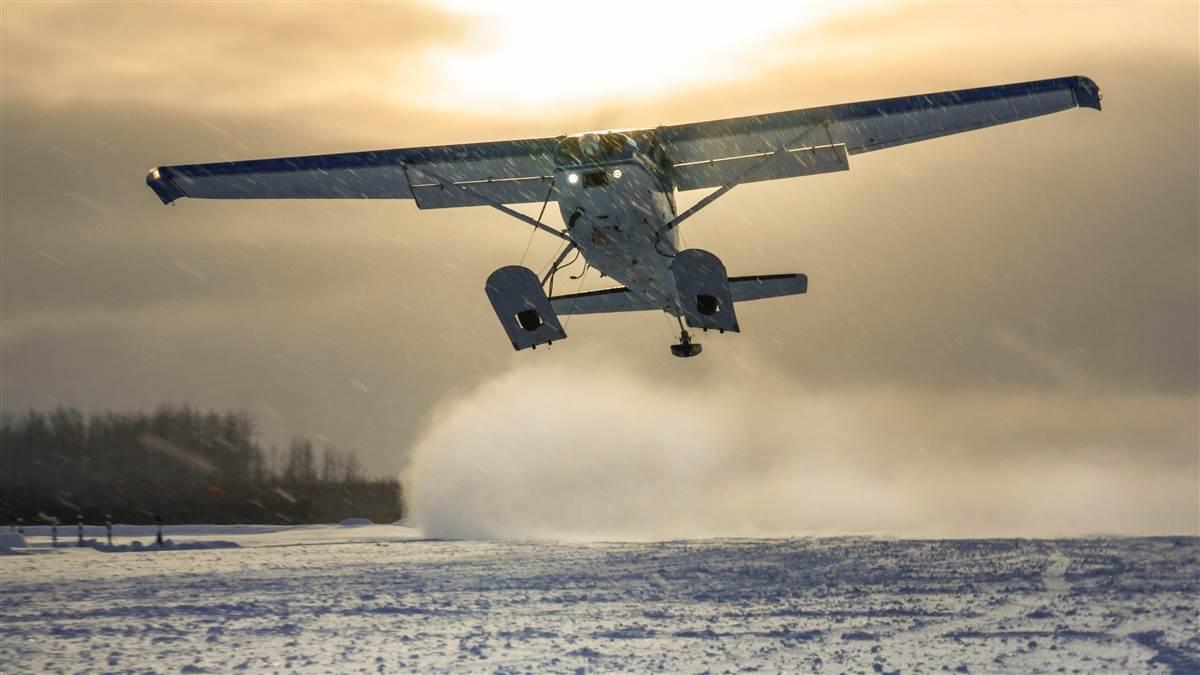 Iditarod Air Force pilot Greg Fischer departs McGrath Airport (AMC) in his Cessna Skywagon in snow so light and dry it sticks to nothing. Photography by Chris Rose.