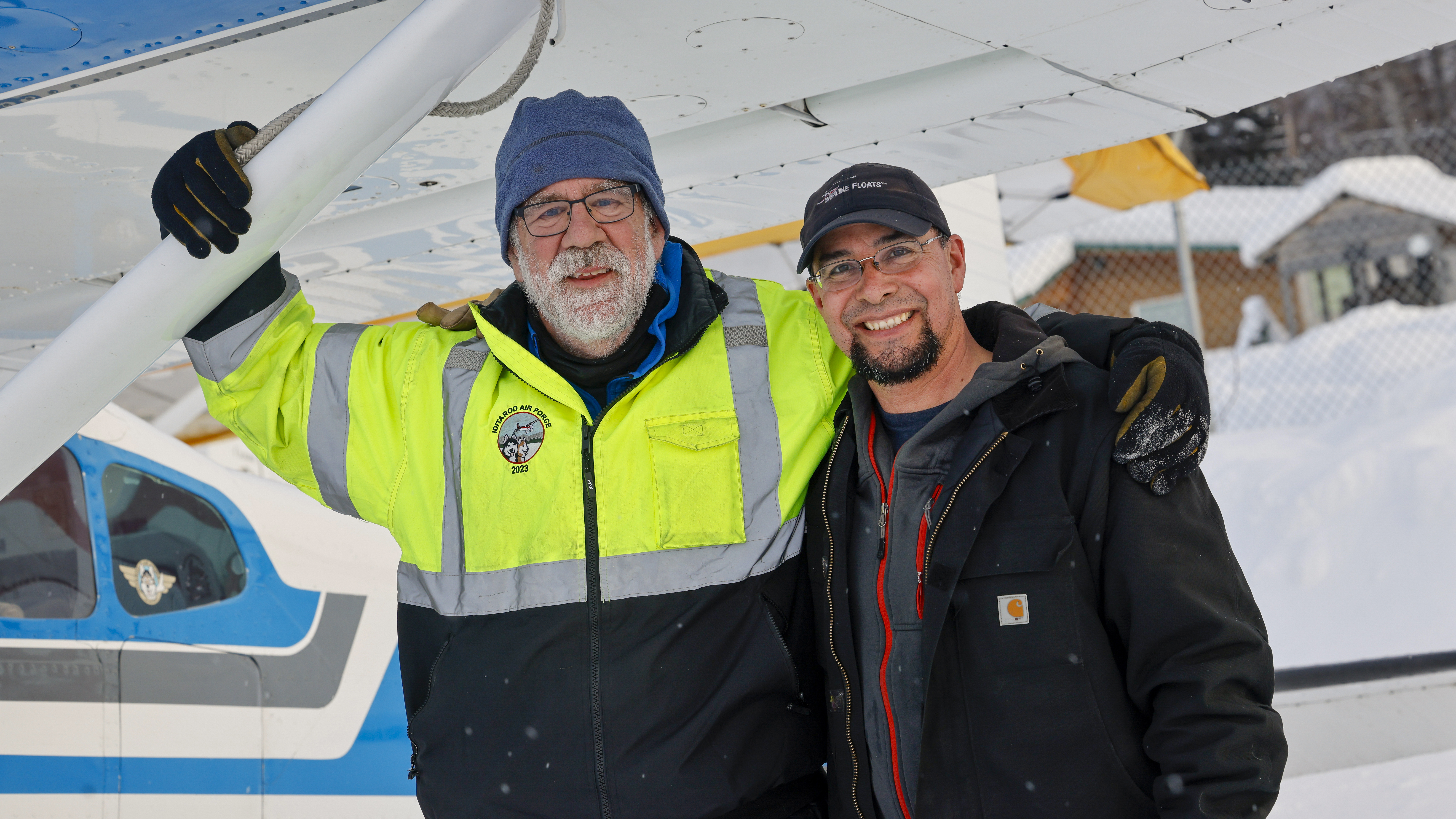 Pilots Greg Fischer and Daniel Hayden pause for a photo on the flightline in McGrath.